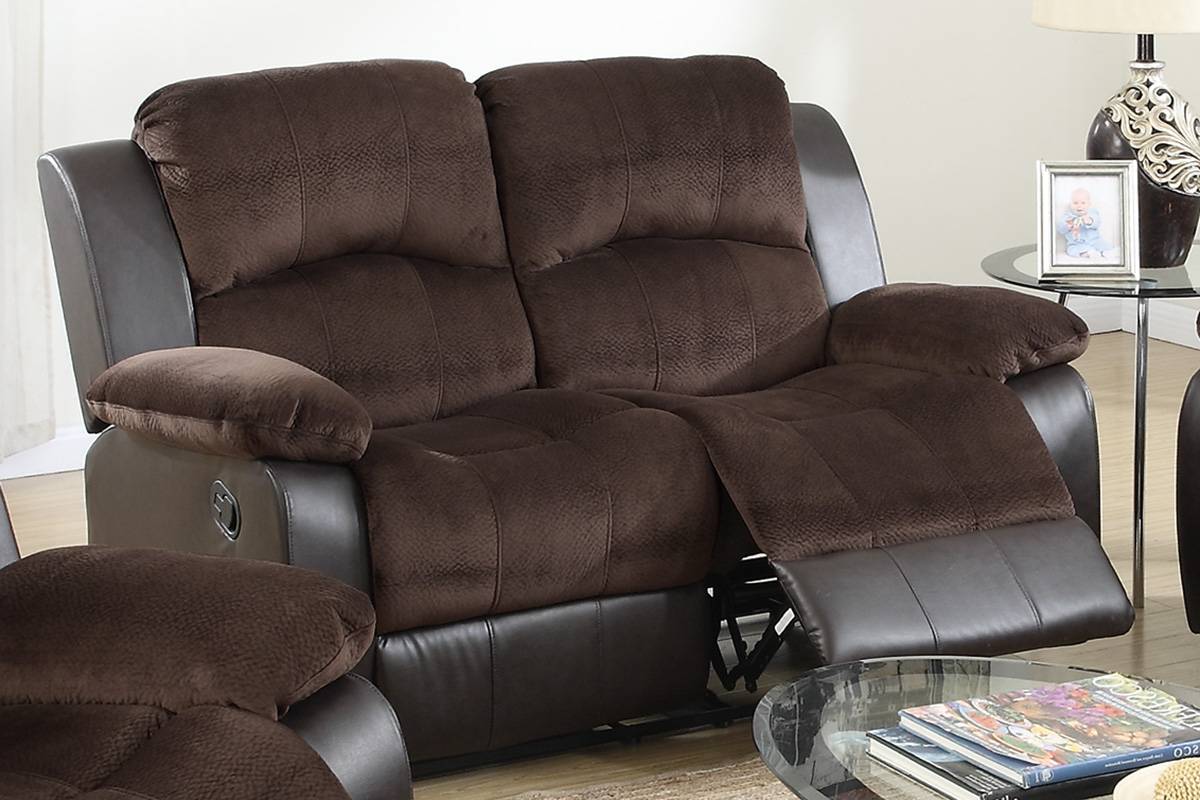 Brown faux leather and suede recliner sofa with plush cushions and extended footrests
