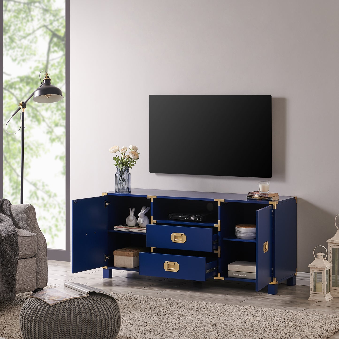 Navy blue campaign style media console with brass hardware for entertainment setup