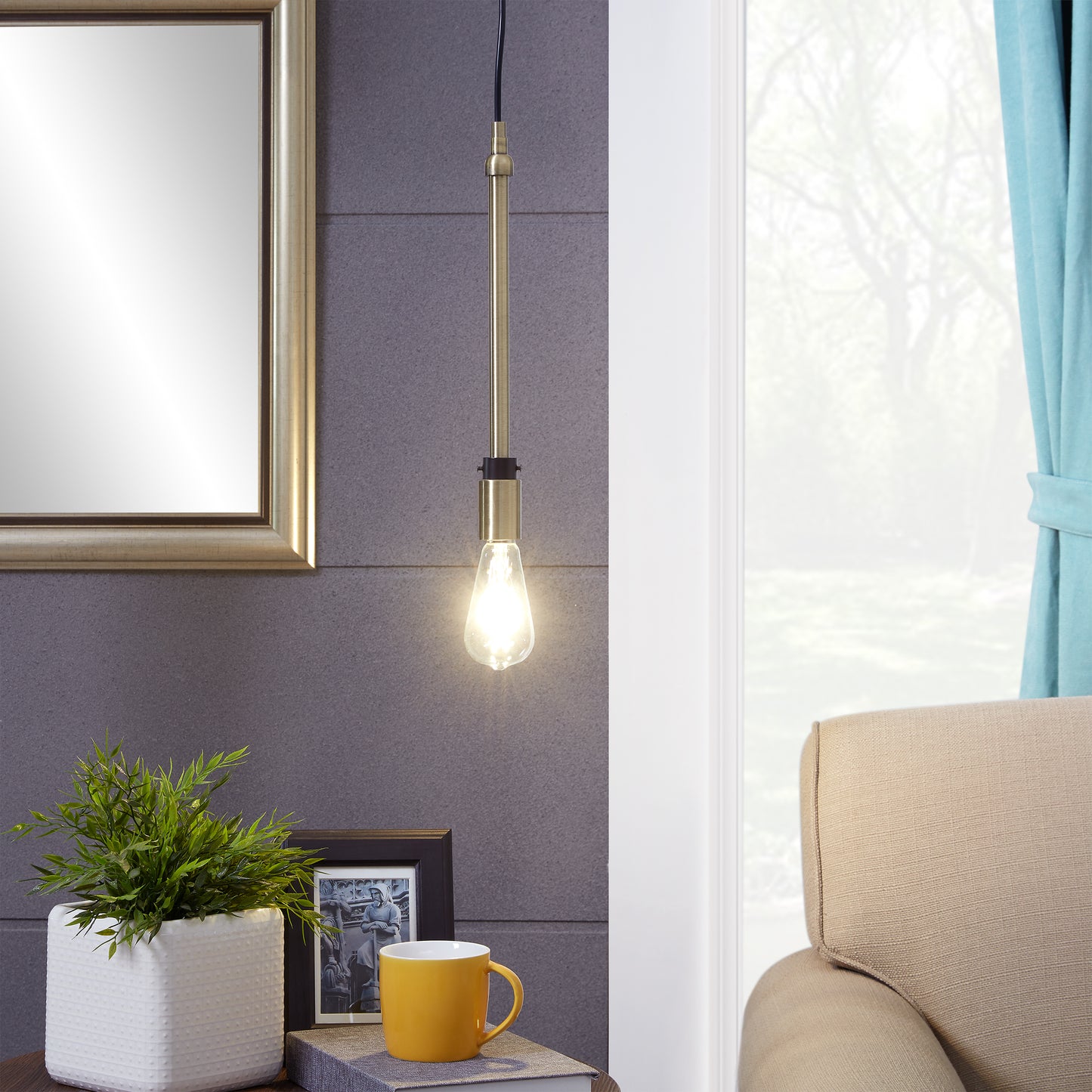 Gold linear pendant light with exposed Edison bulb