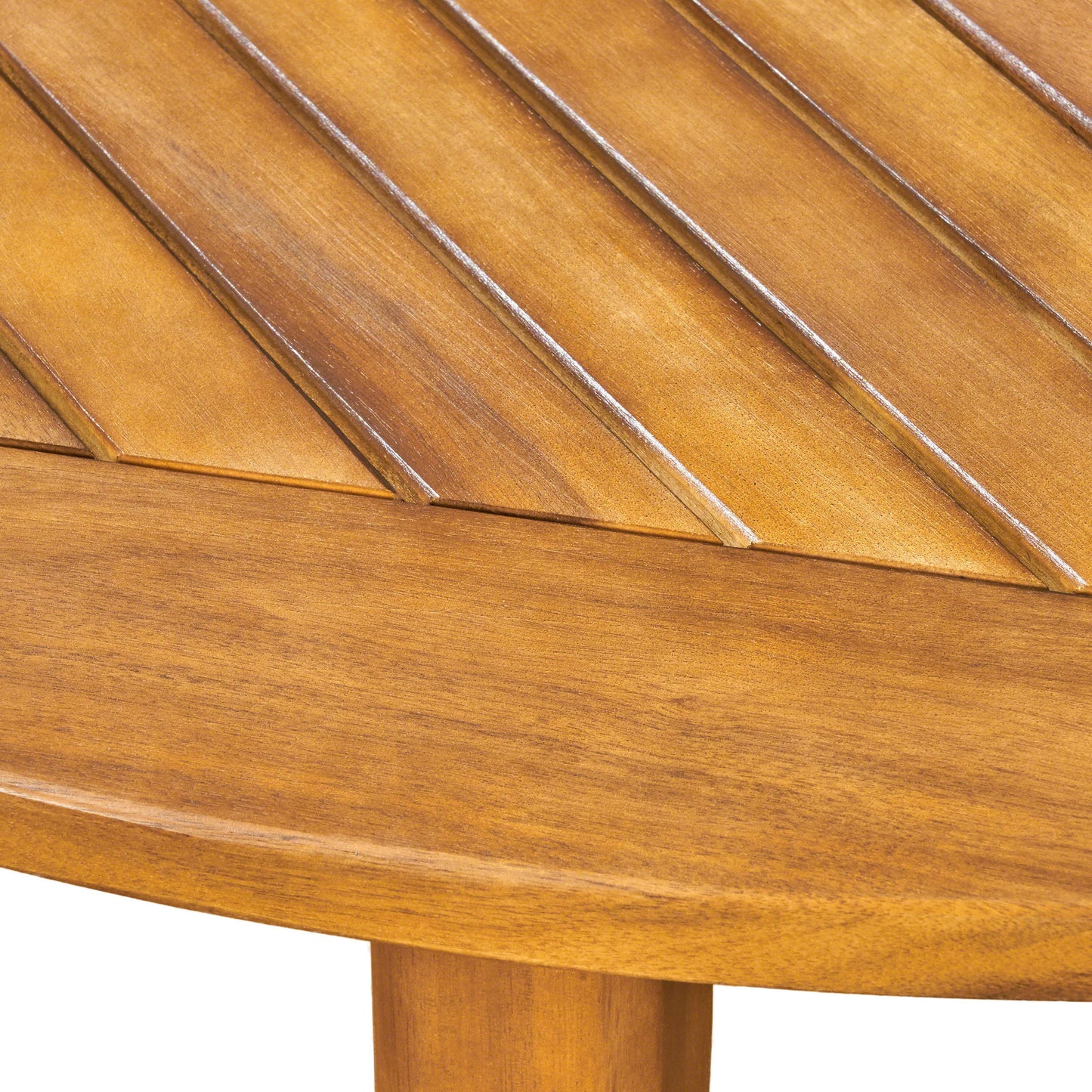 Closeup of a natural wood picnic table surface with slatted design