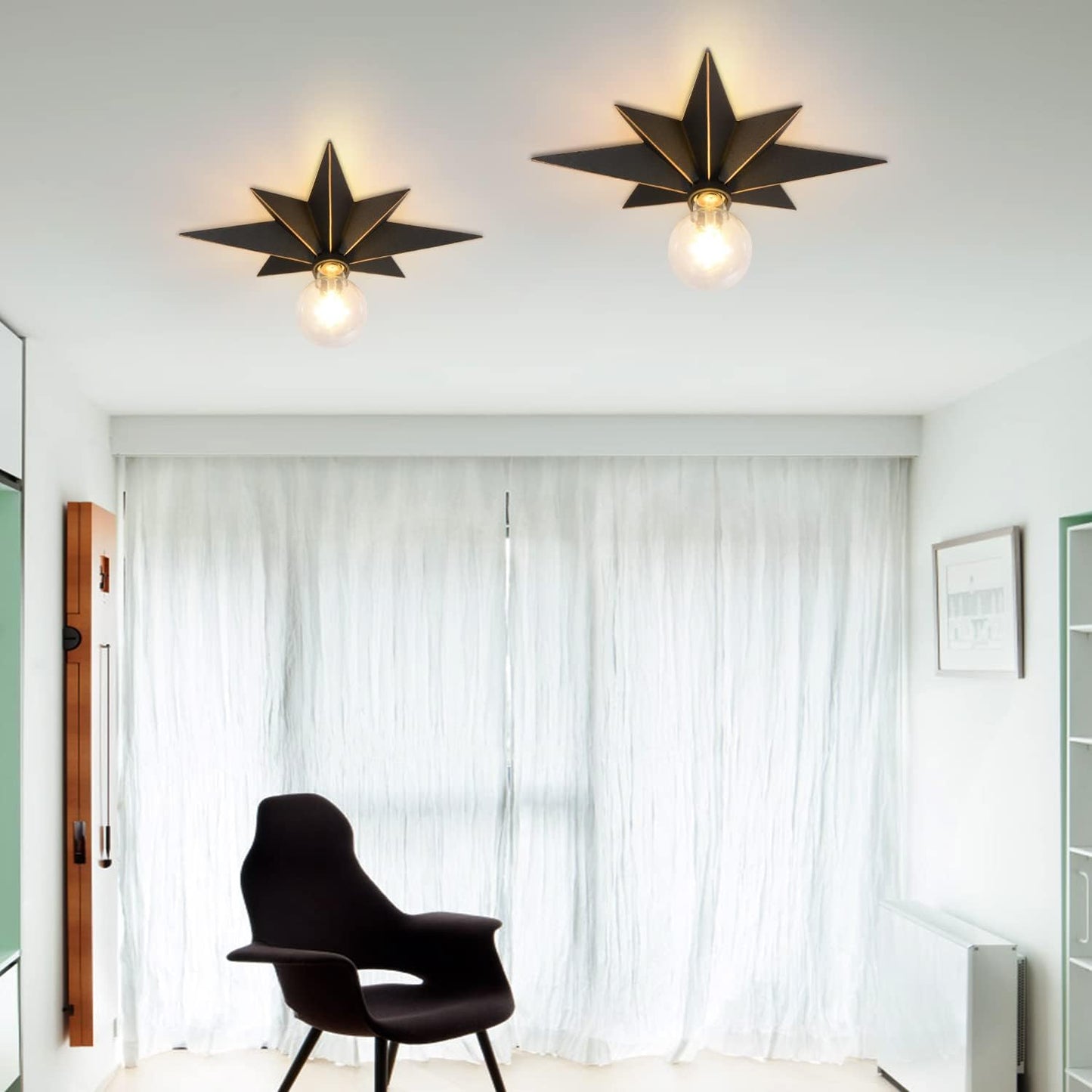 Two black starburst ceiling lights with exposed Edison bulbs illuminate a modern room