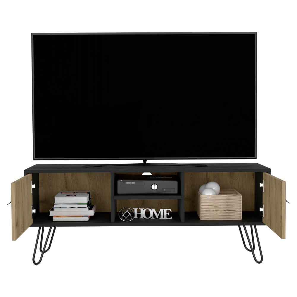 Black and oak TV stand with hairpin legs holding a television game console books and decorative items