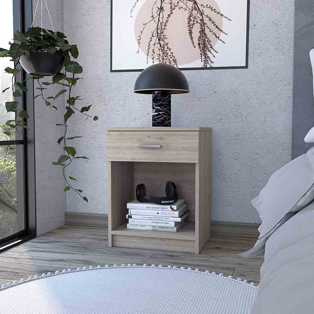 Light wood bedside table with drawer open shelf and stacked books