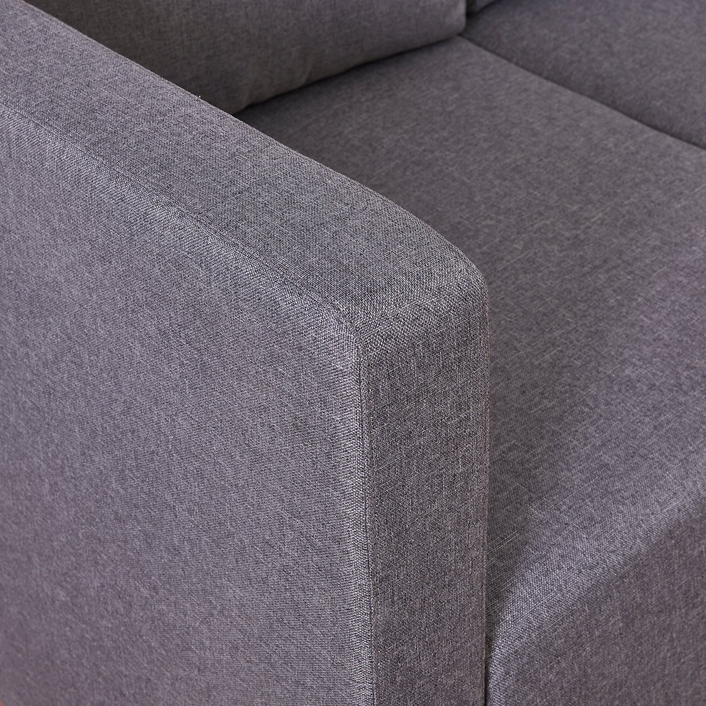 Closeup of a charcoal grey fabric couch armrest showcasing textured woven material