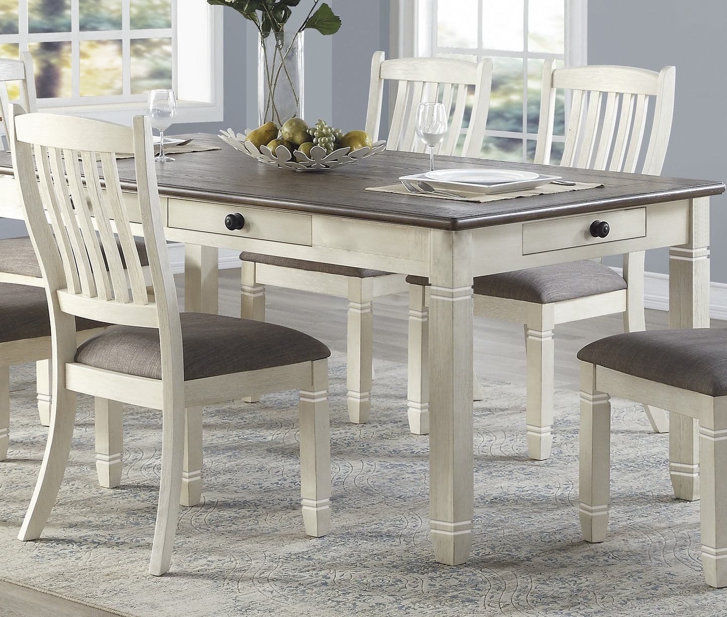 Farmhouse dining table with two drawers and upholstered chairs