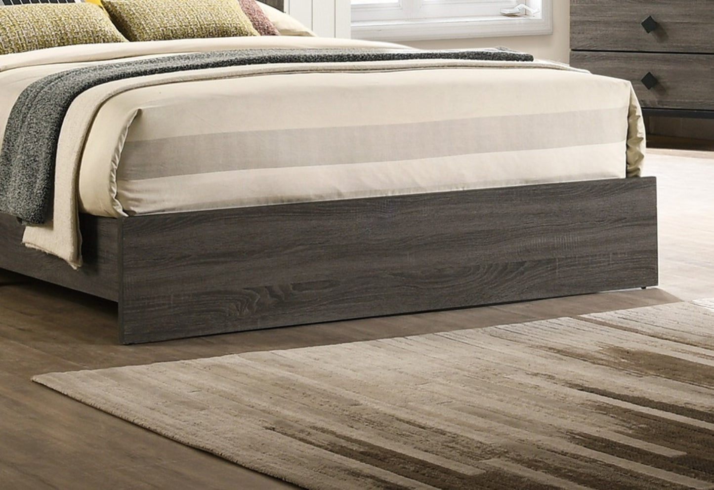 Dark gray wood platform bed frame with neutral striped bedding