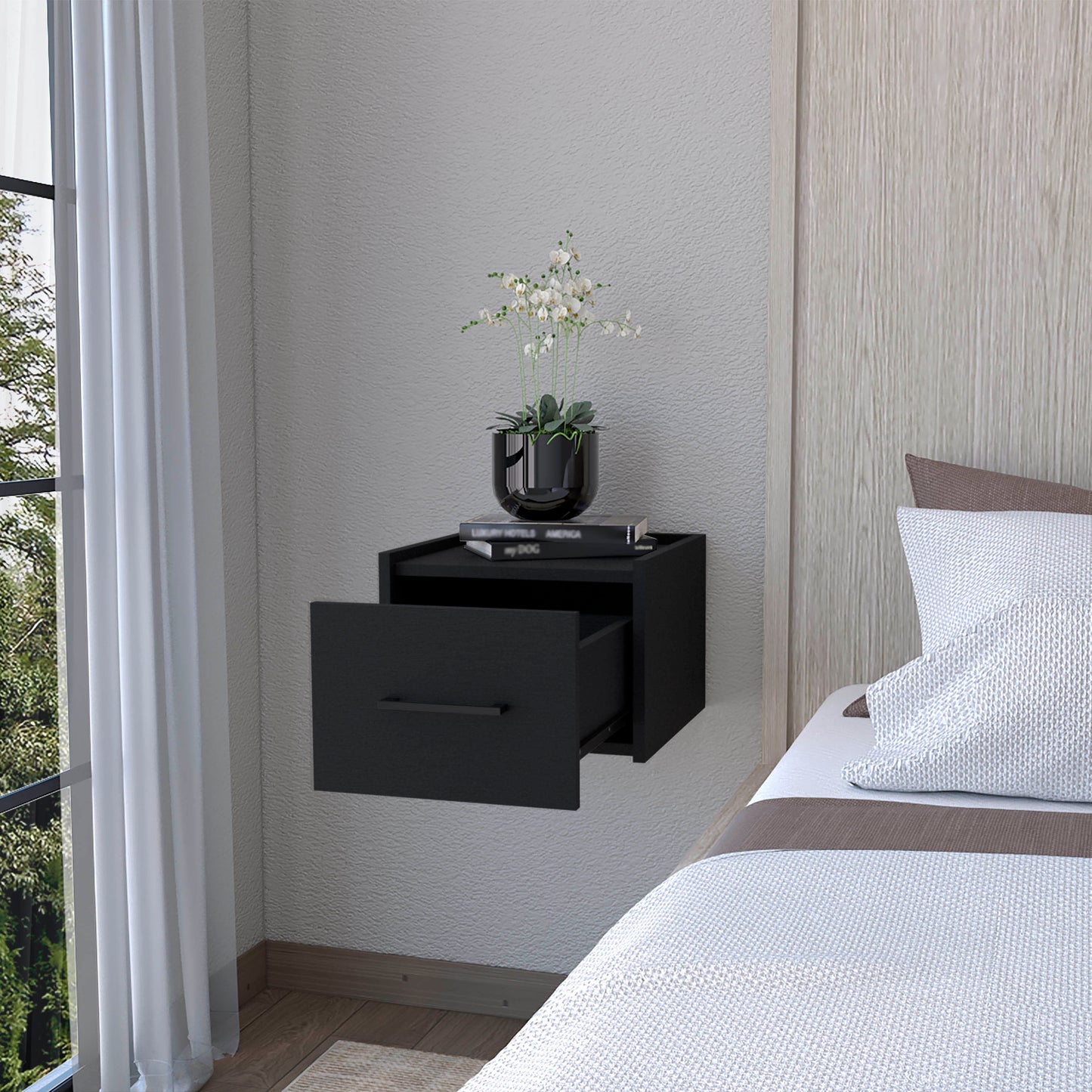 Modern black wallmounted nightstand with a single open drawer and minimalist handle