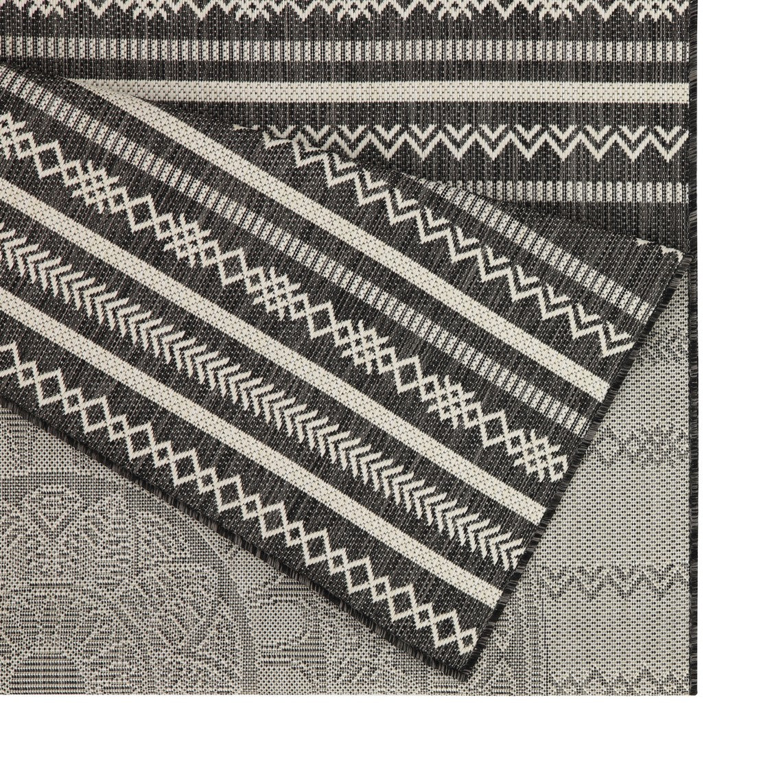 Indoor outdoor rug with black and white geometric tribal pattern