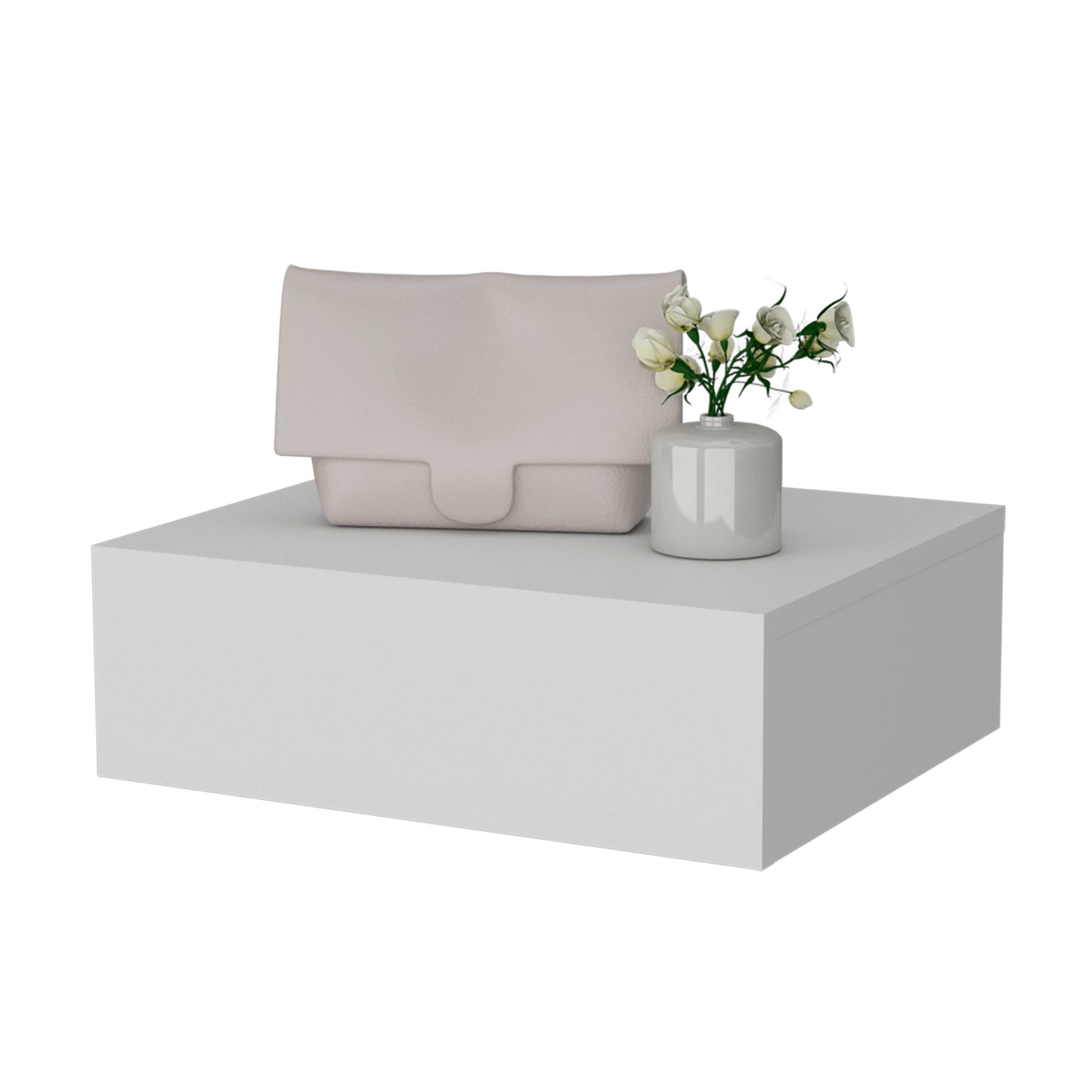 A pale pink textured leather clutch bag with a smooth flap closure rests on a white display pedestal