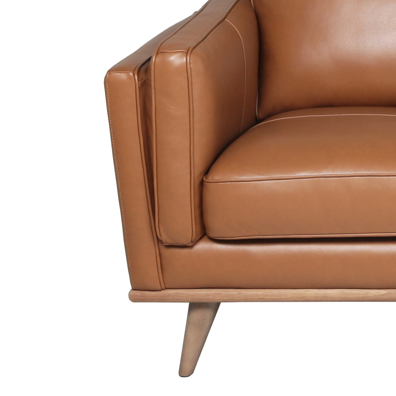 Tan leather armchair detail with clean lines and wooden legs MidCentury modern style