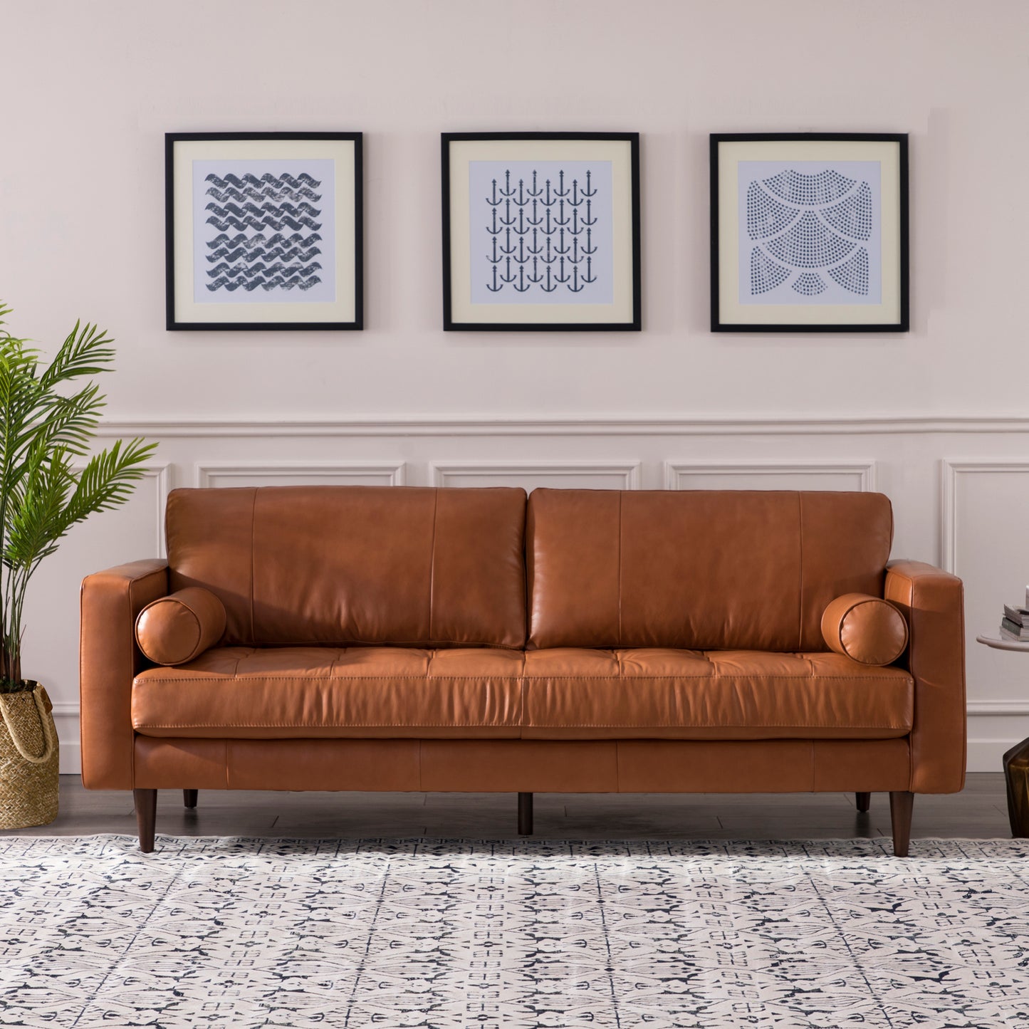 Classic brown leather sofa with tufted seat cushions and bolster arms
