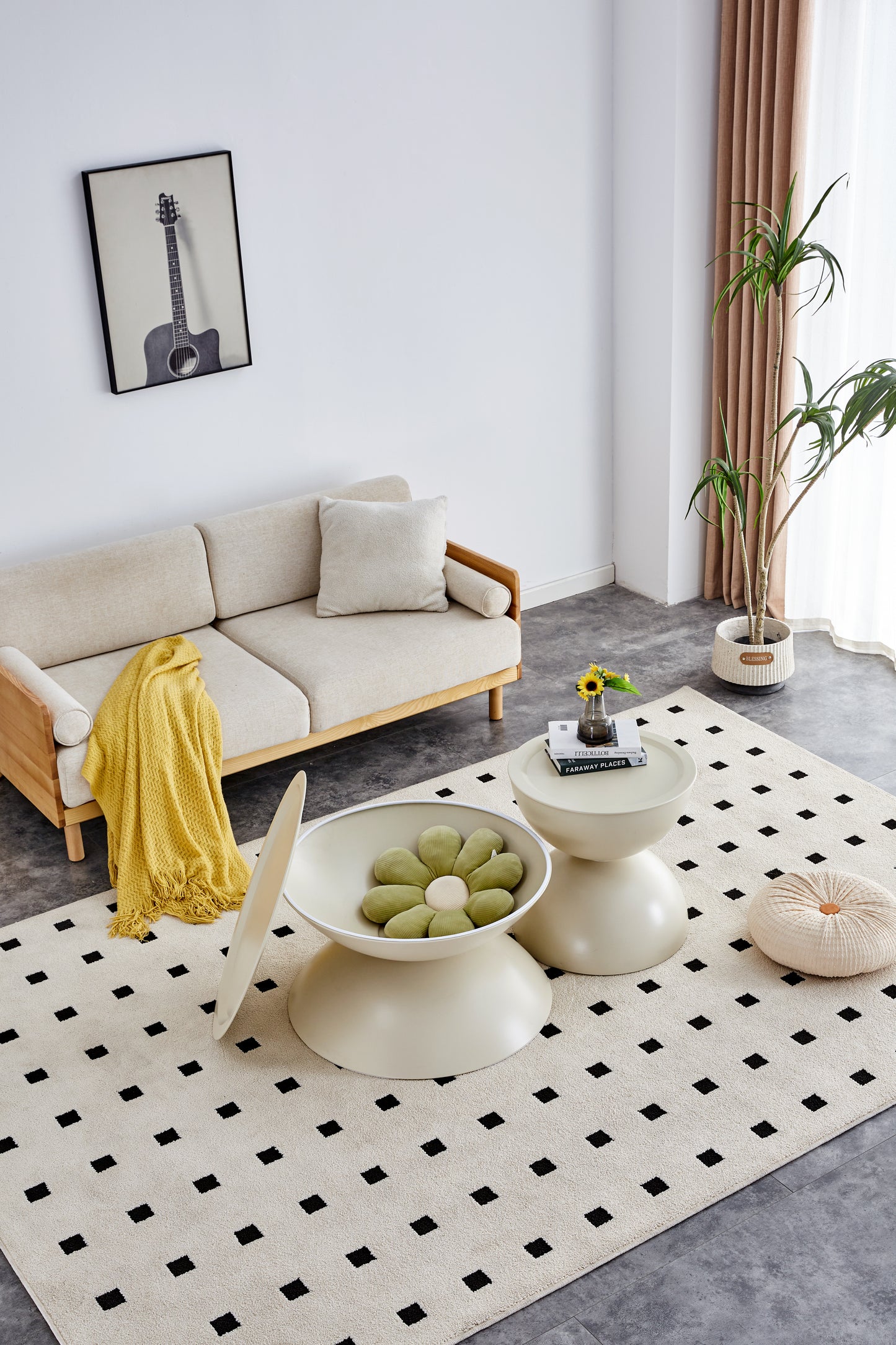 Beige linen sofa with wooden arms adorned with a yellow fringed throw blanket