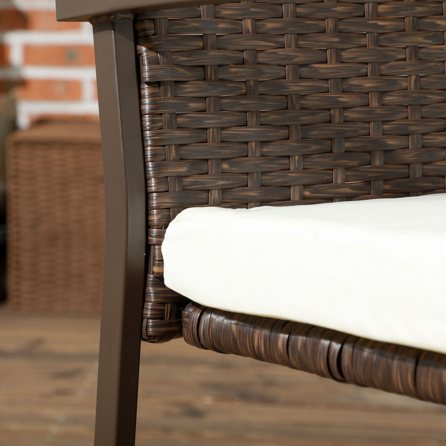 Brown rattan chair frame with a textured weave and white cushion