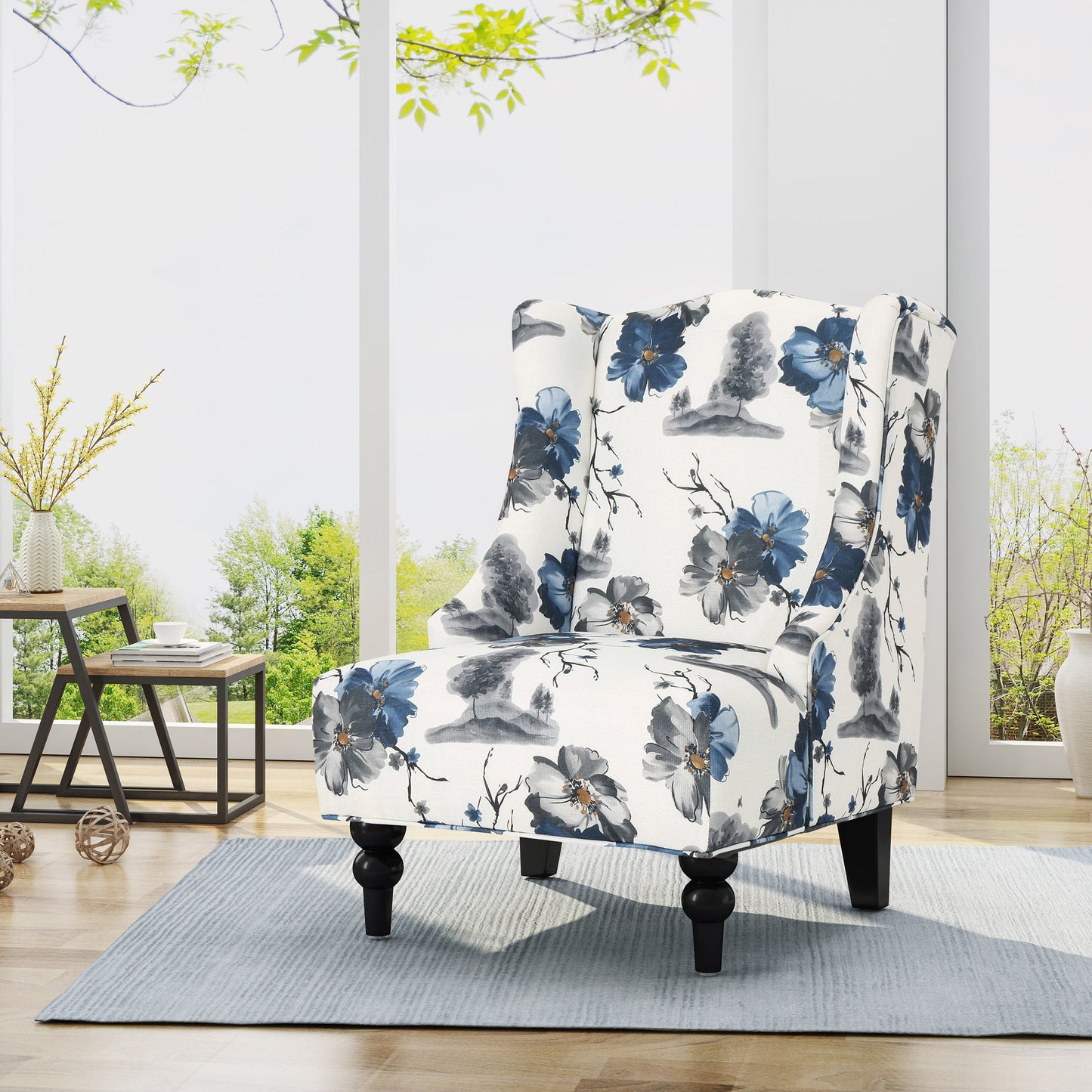 Wingback chair with blue floral print upholstery and dark wood legs