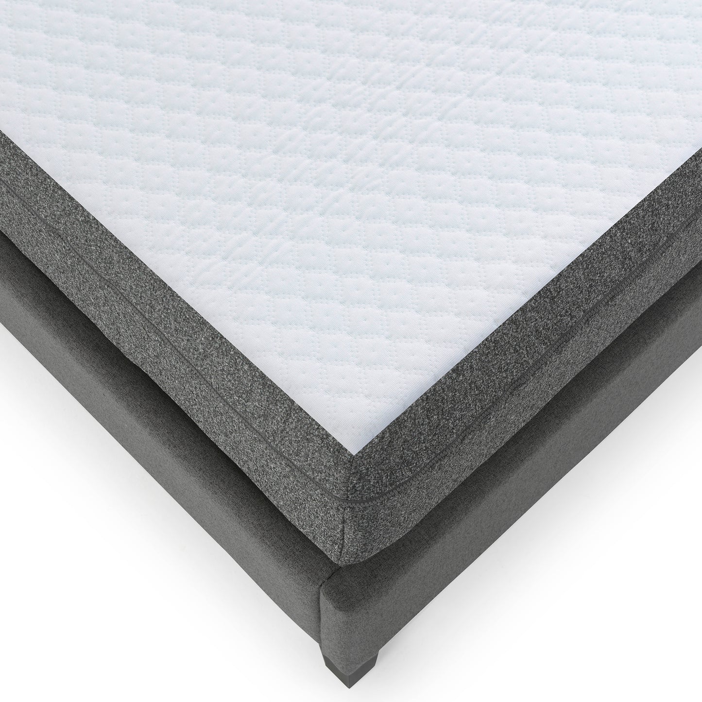 Close up of a quilted white mattress top with grey fabric border on a grey bed frame