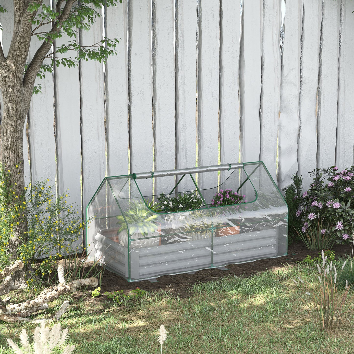 Transparent portable greenhouse with green trim housing various potted plants and flowers