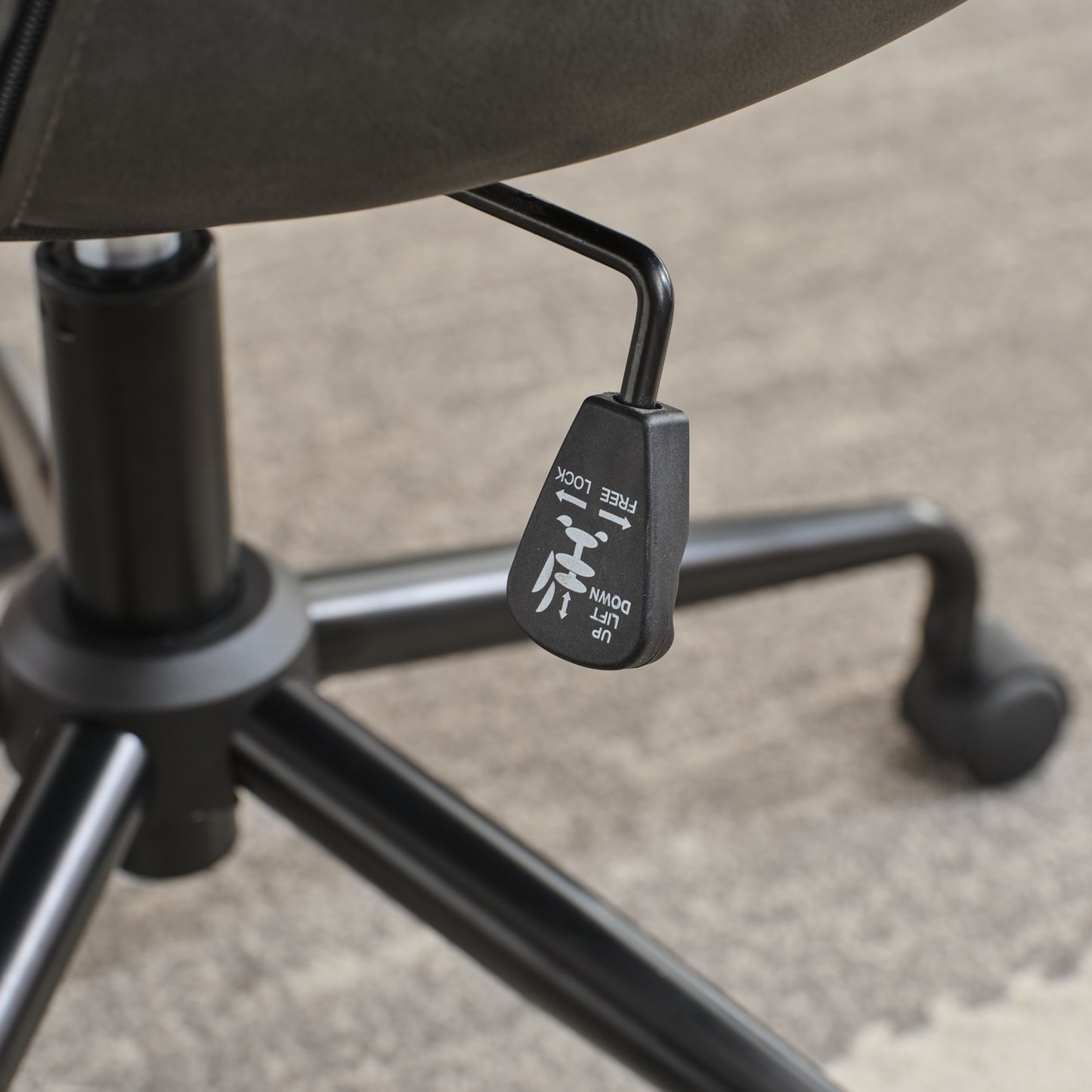 Black office chair tilt mechanism lever with UP and DOWN labels