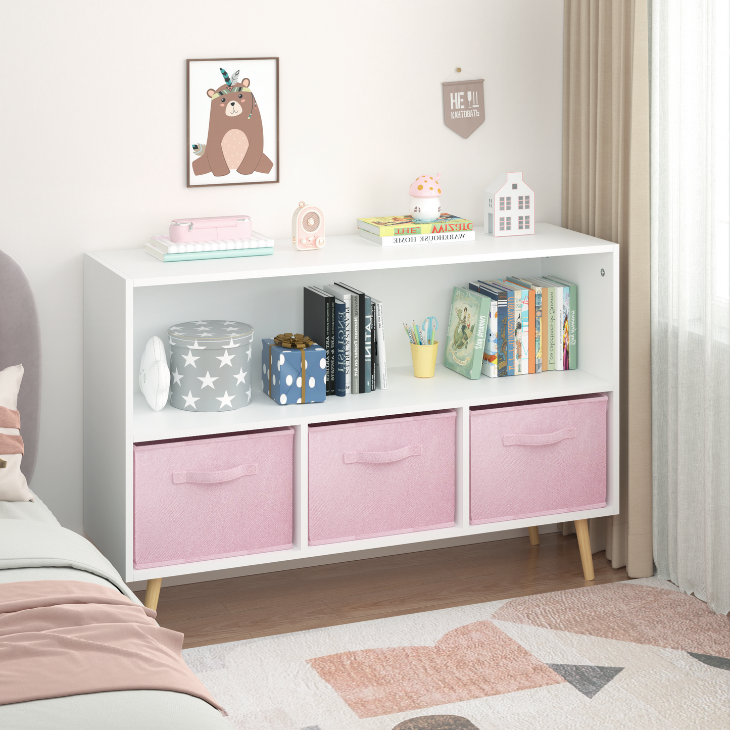 White bookshelf with three pink fabric storage cubes and wooden legs ideal for childrens rooms