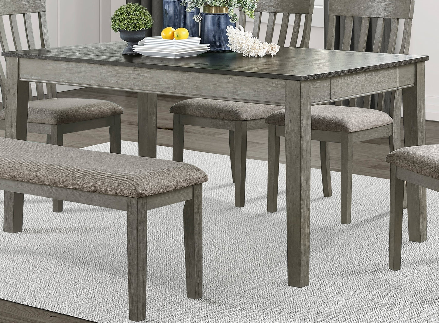 Gray wood dining table with bench and upholstered chairs