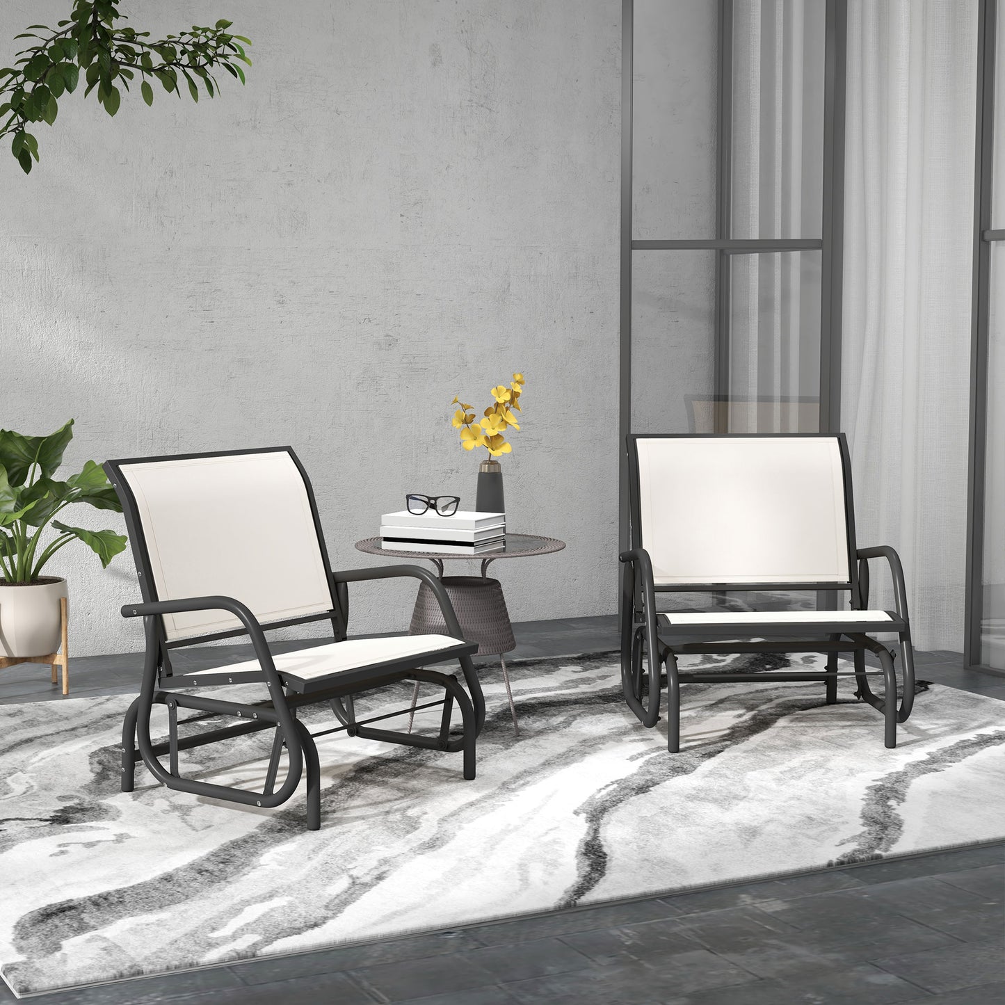Two black metal outdoor glider chairs with white cushions on a patterned rug