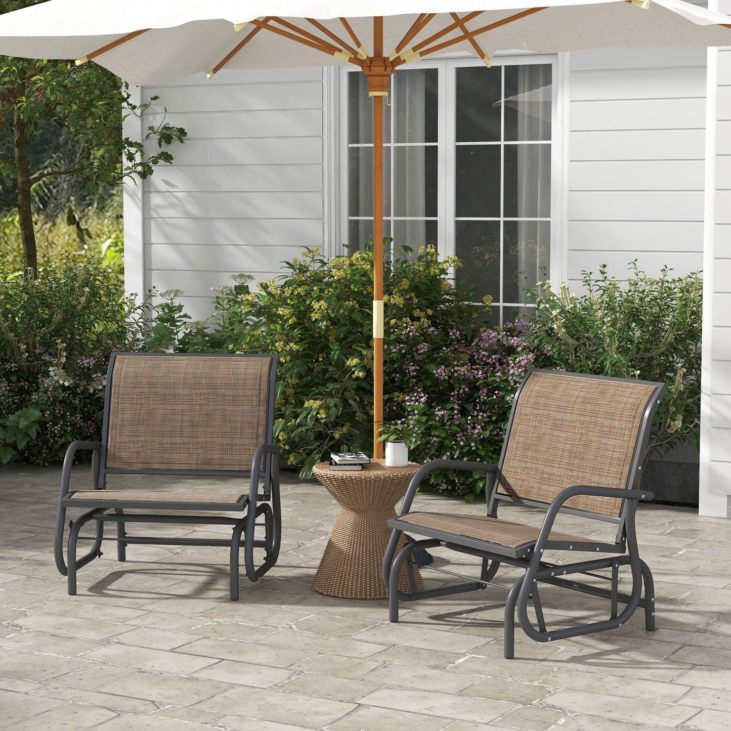 Gray metal outdoor glider chairs with tan fabric seats on a patio
