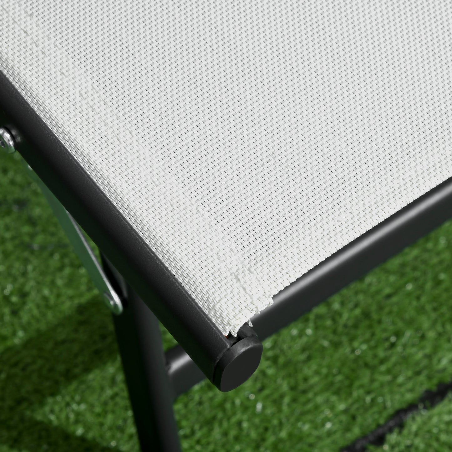 Close up of a white mesh fabric patio chair with black frame