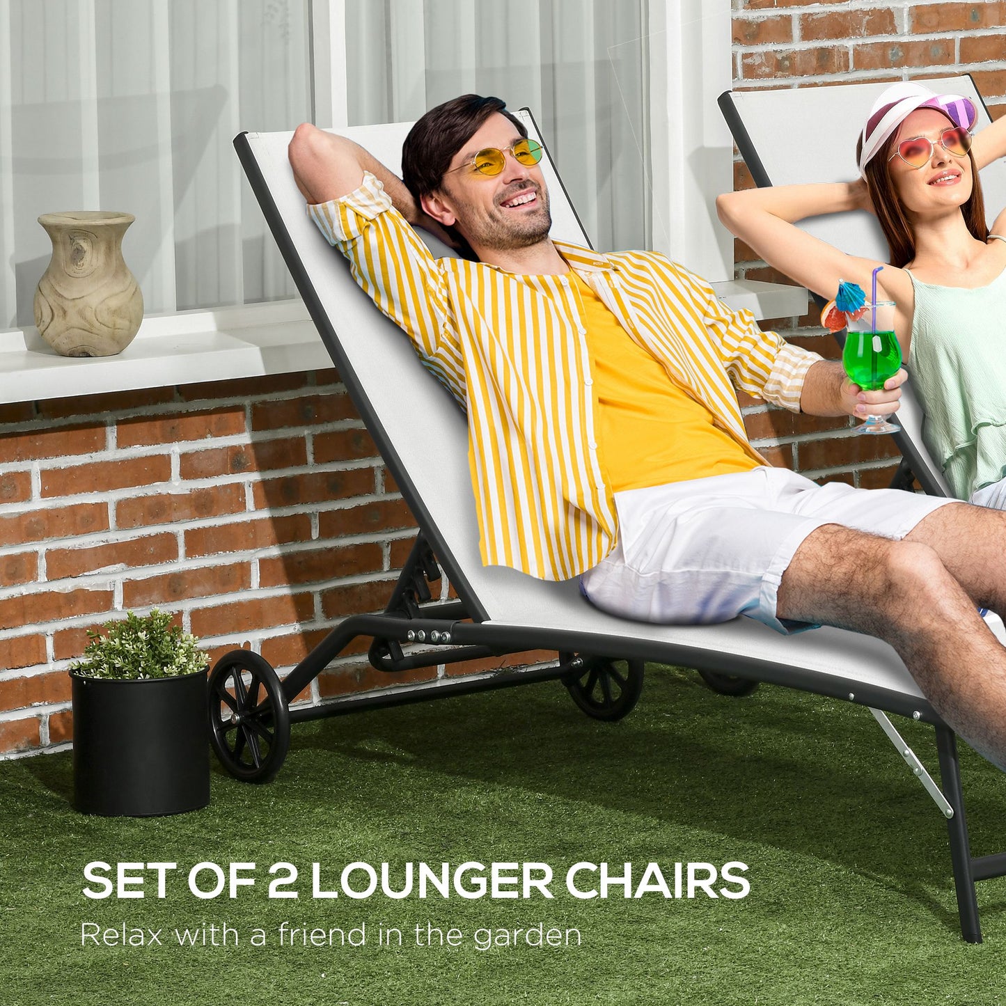 Two white fabric lounger chairs with black frames and wheels on green grass