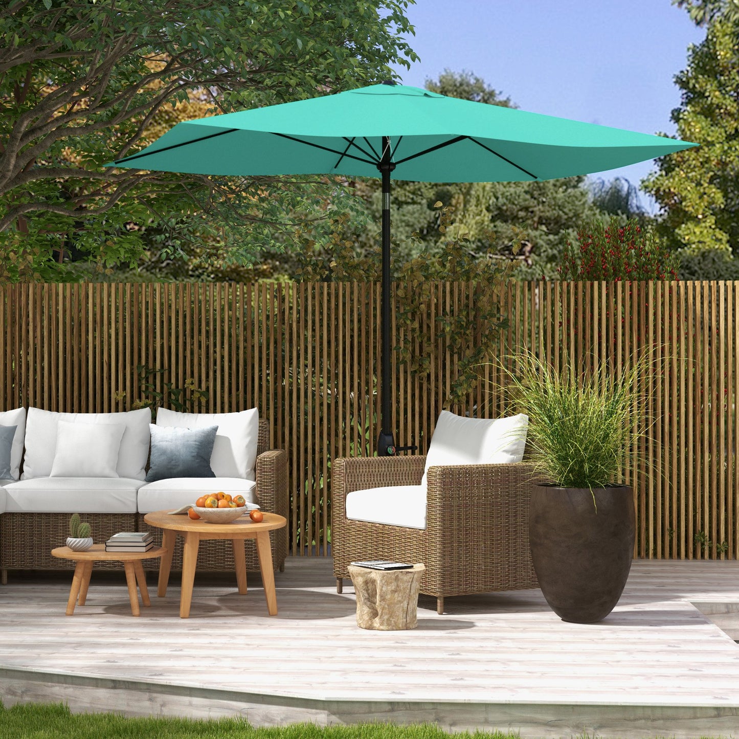 Large teal patio umbrella open over outdoor furniture on a wooden deck