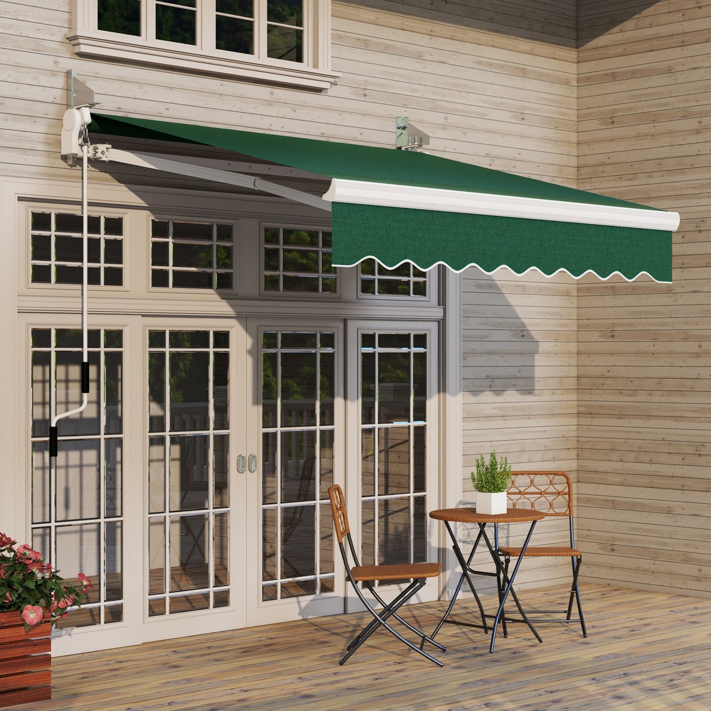 Green retractable patio awning with decorative scalloped valance and manual crank