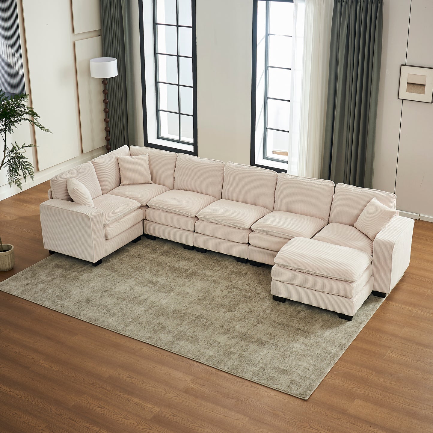 Plush pink corduroy Ushaped sectional sofa with chaise and multiple cushions perfect for family rooms