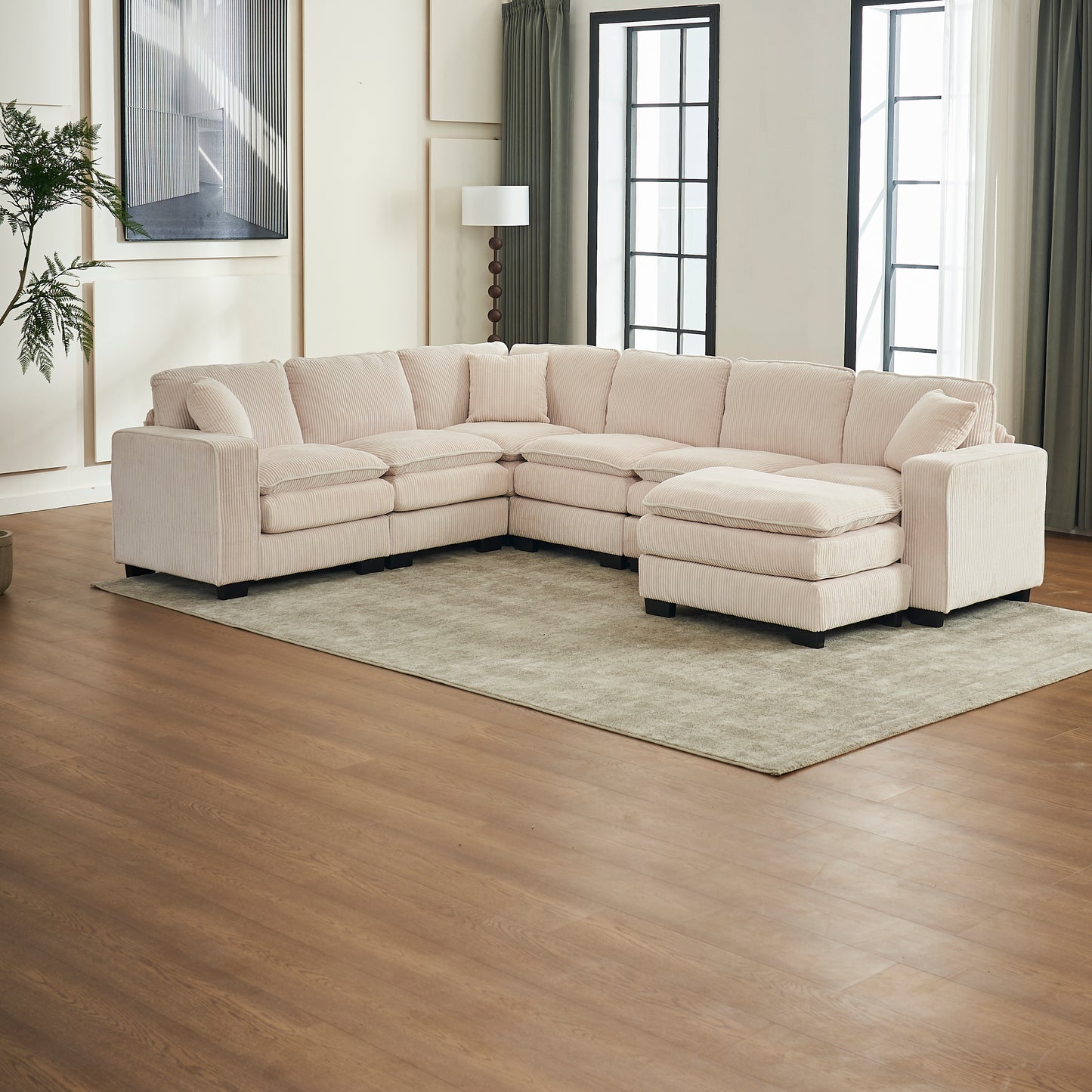 Large beige corduroy sectional sofa with chaise and ottoman in a modern living room