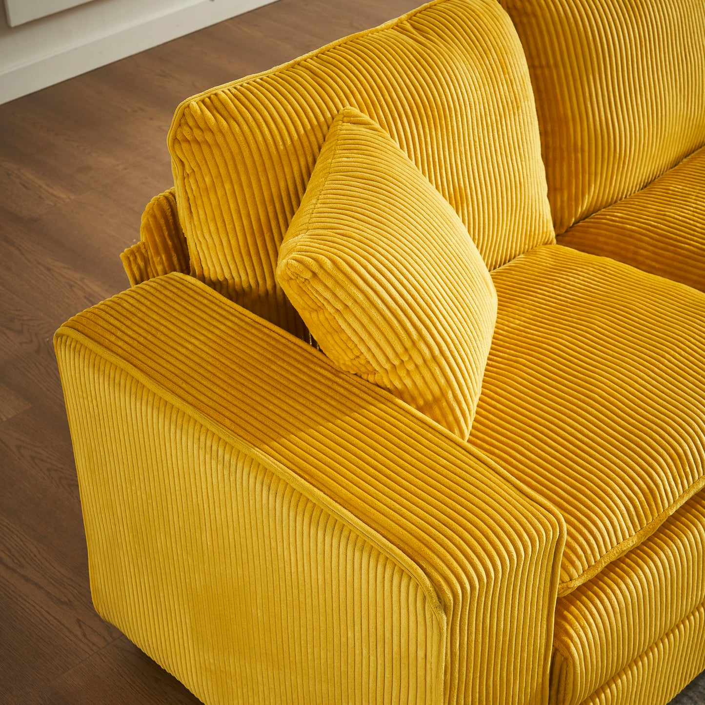 Luxurious mustard yellow corduroy sofa with deep inviting cushions and a modern design