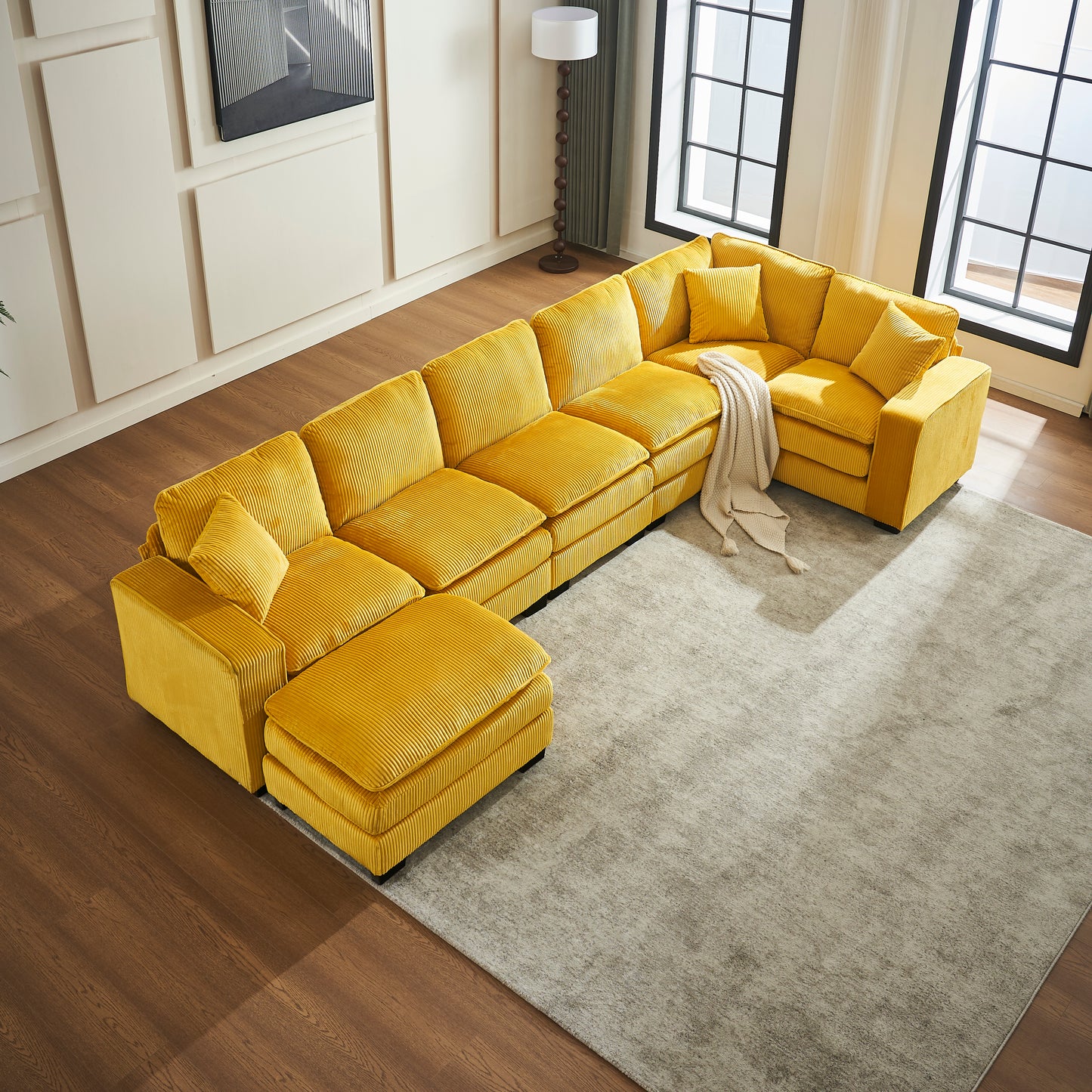 Bright yellow corduroy sectional sofa with ottoman and plush cushions perfect for modern living rooms