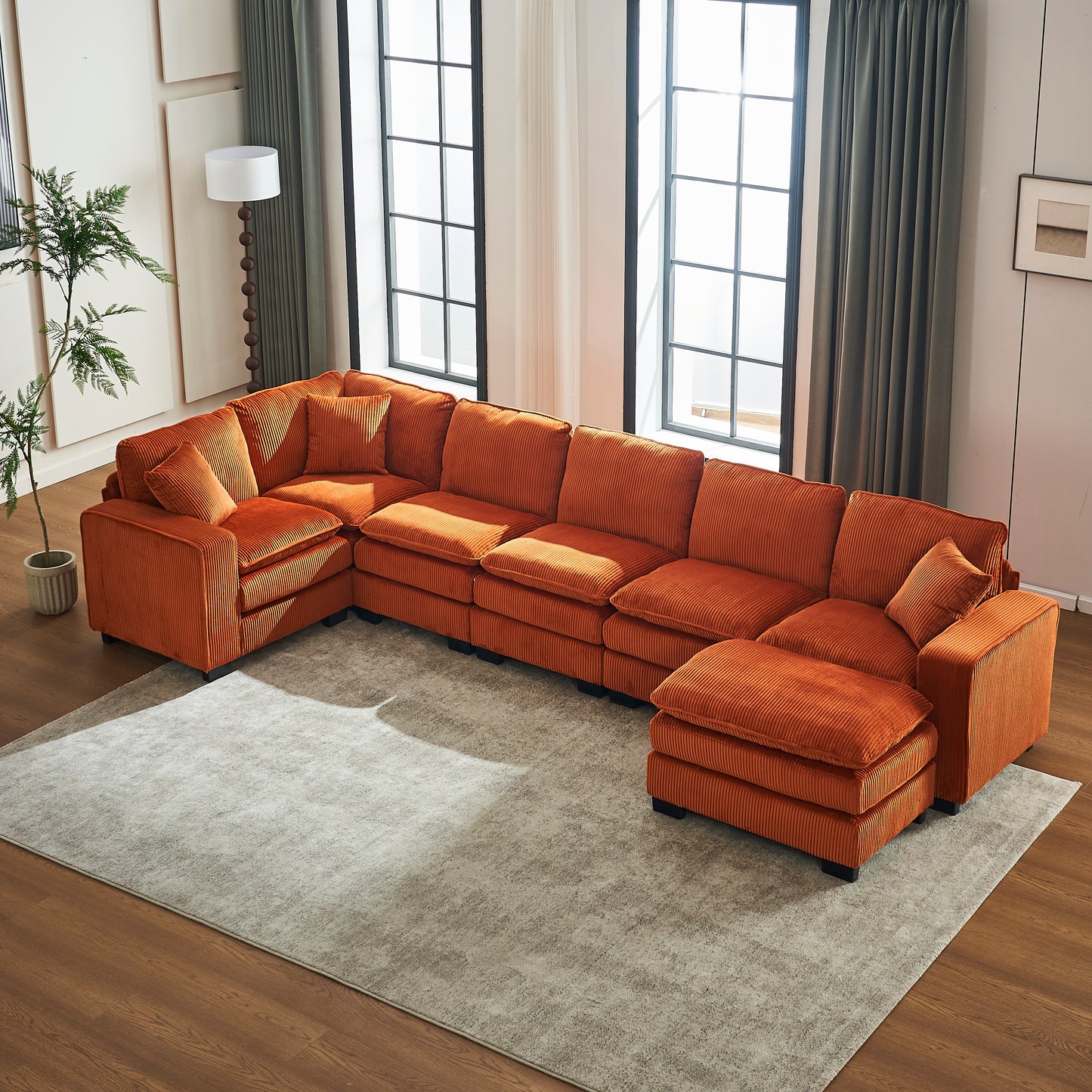 Plush orange corduroy sectional sofa with chaise and ottomans for a modern living room