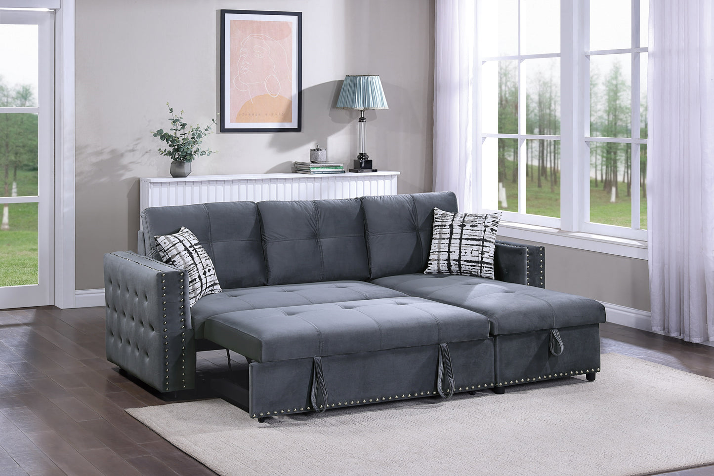 Dark grey velvet sectional sofa with pullout bed option and decorative nailhead trim