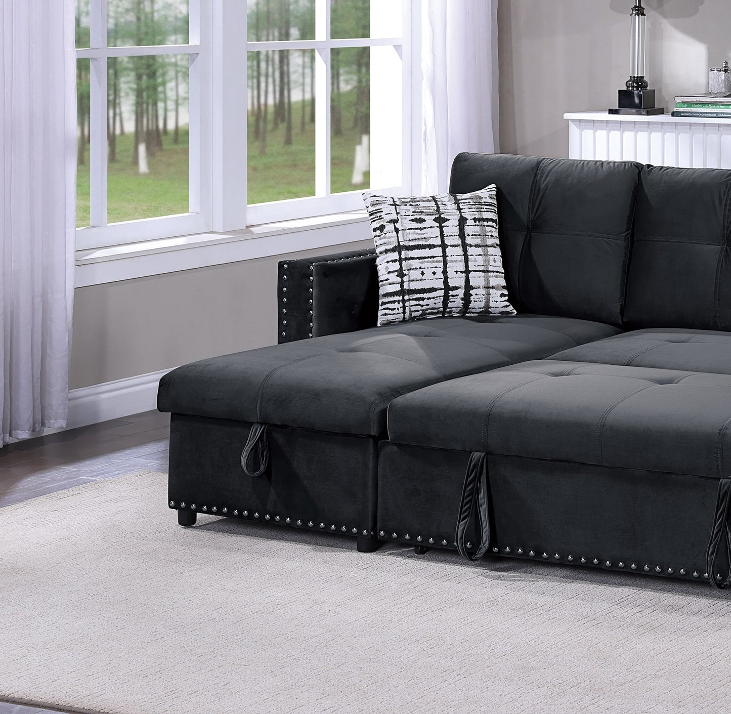 Dark gray velvet sectional sofa with tufted cushions and nailhead trim