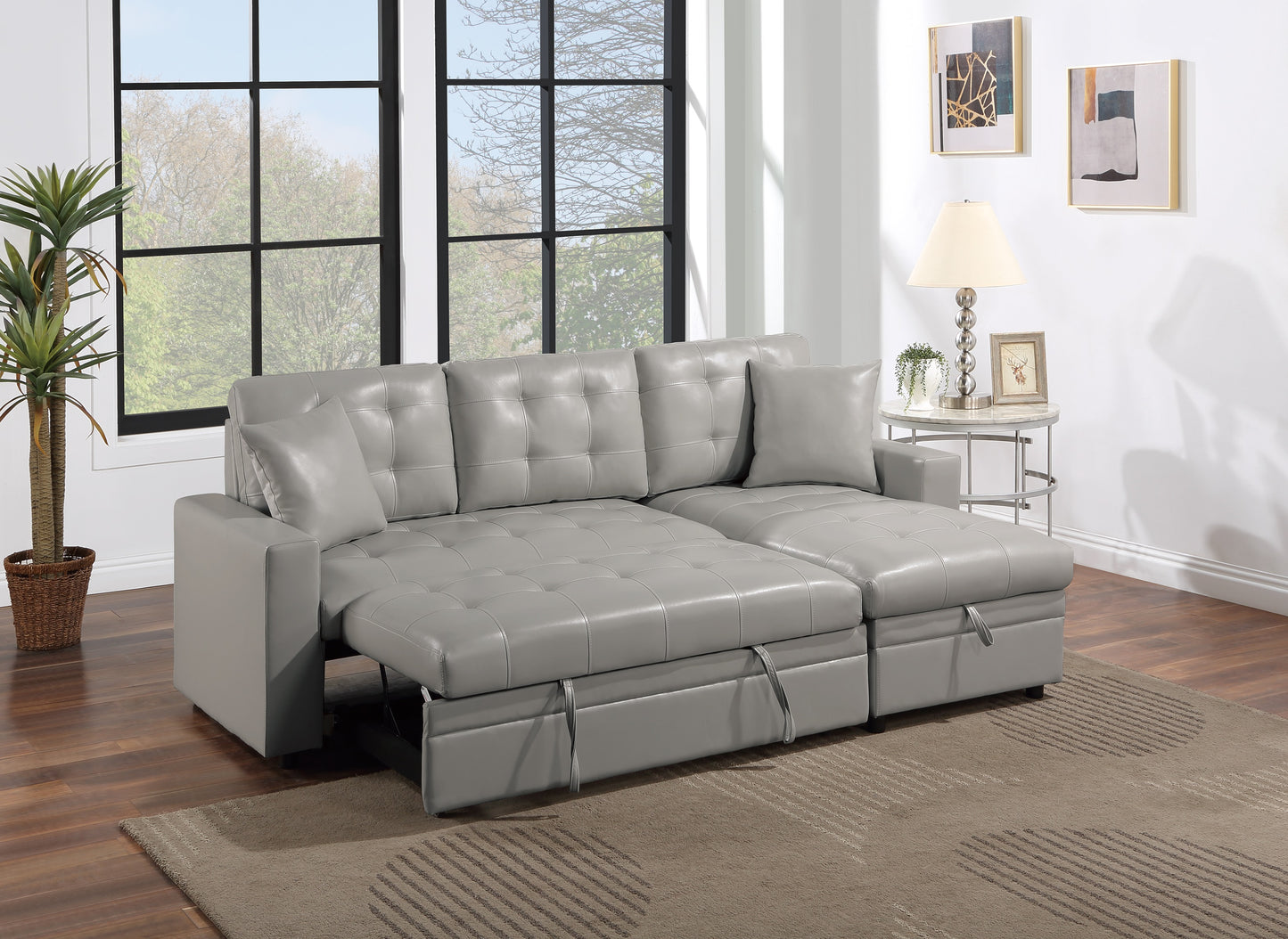 Gray leather sectional sofa with pullout bed functionality and storage