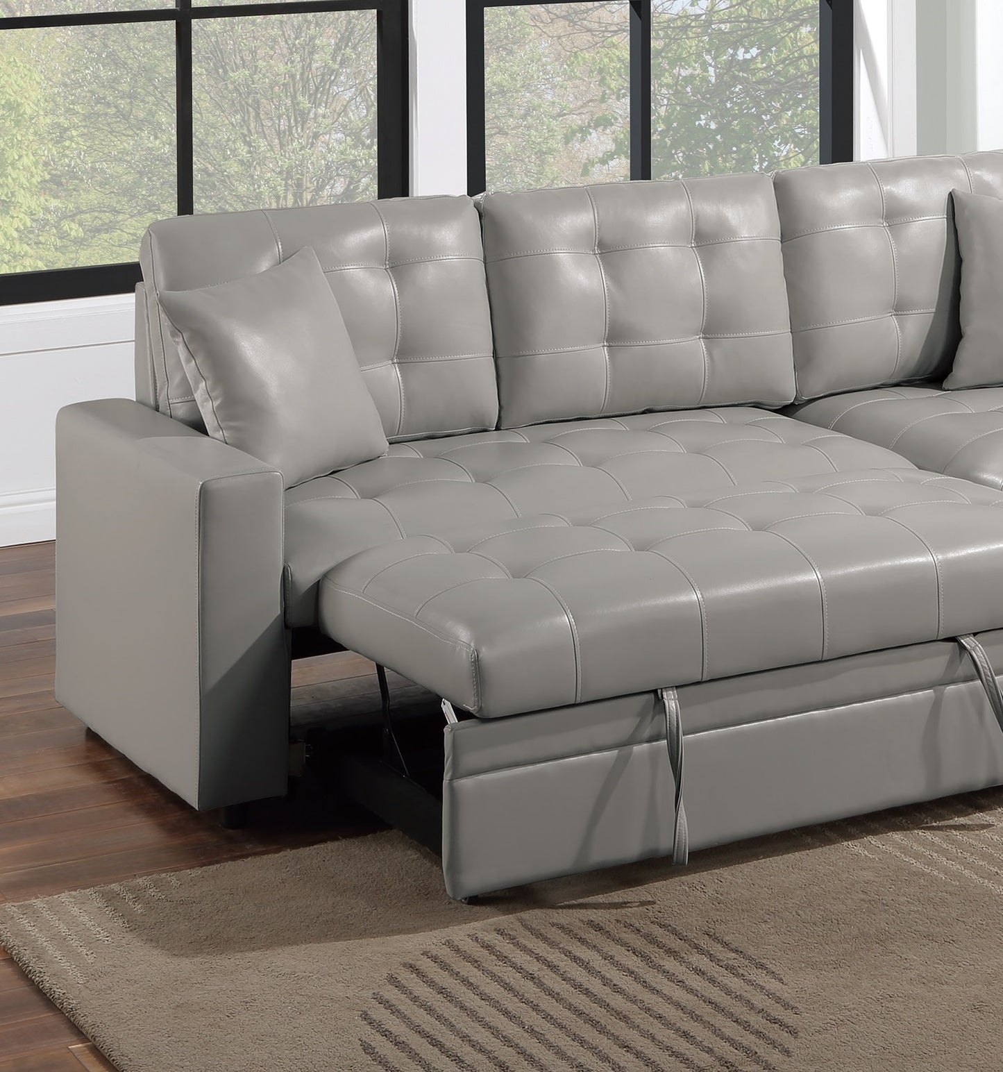 Gray tufted leather sofa with pullout bed feature extended