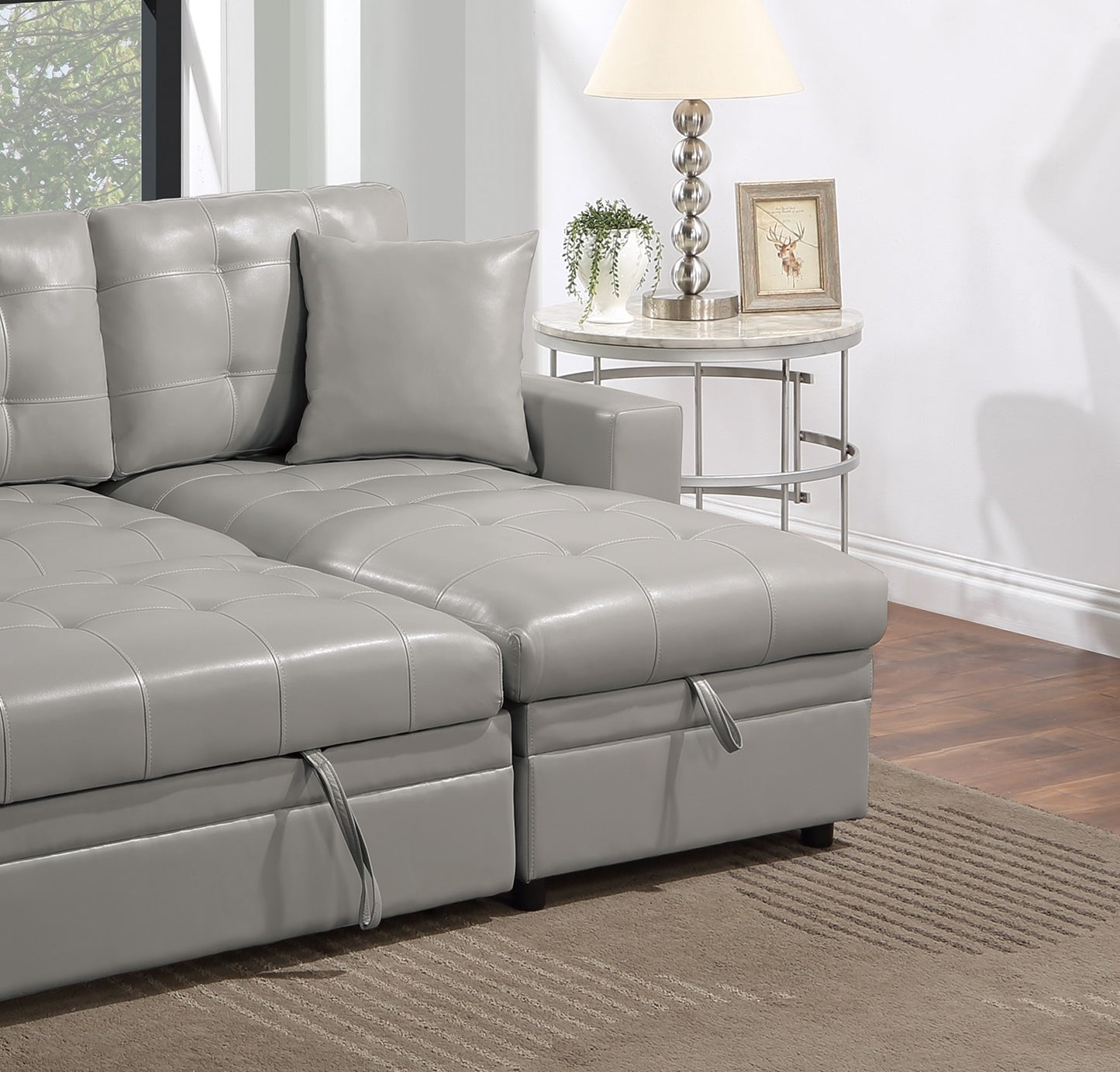 Gray tufted leather sectional sofa with storage ottoman feature