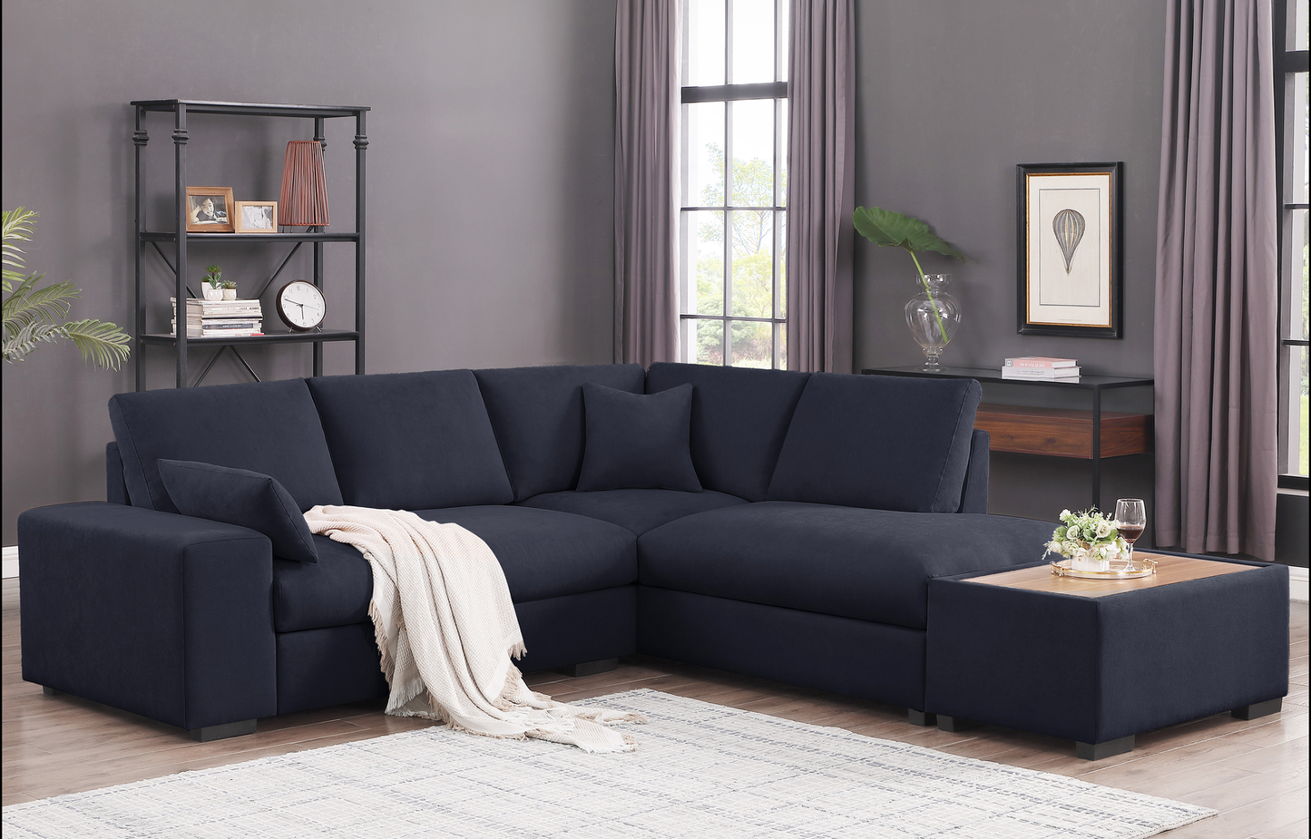 Navy fabric sectional sofa with plush cushions and throw blanket