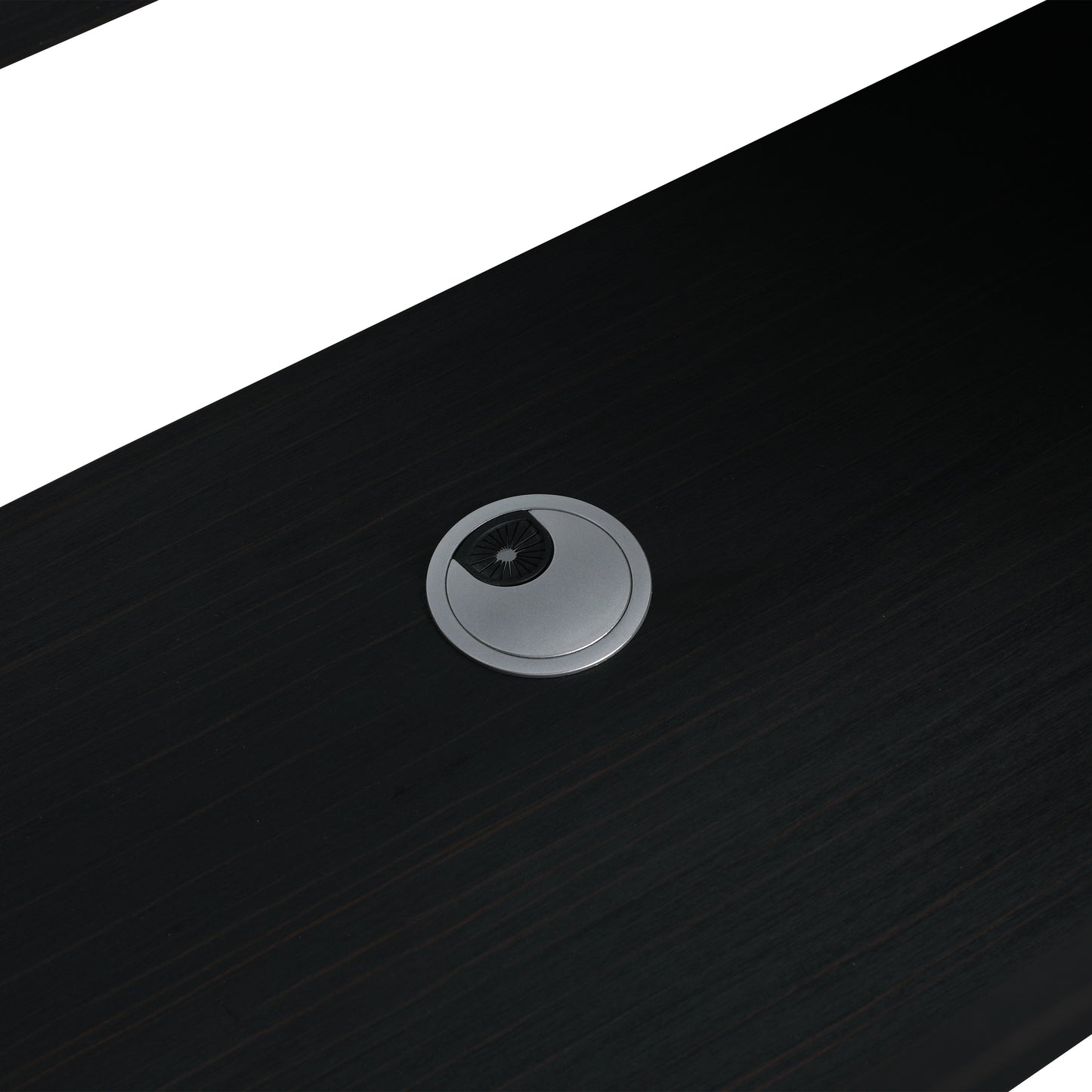Dark wood desk surface with a sleek silver grommet for cable management