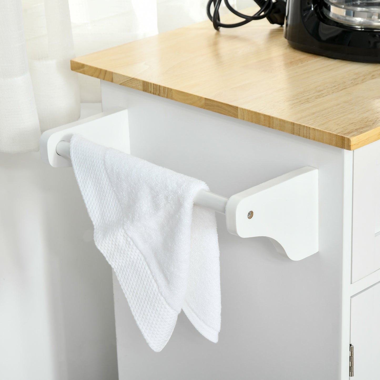 White towel bar with white textured towel hanging on a kitchen cart
