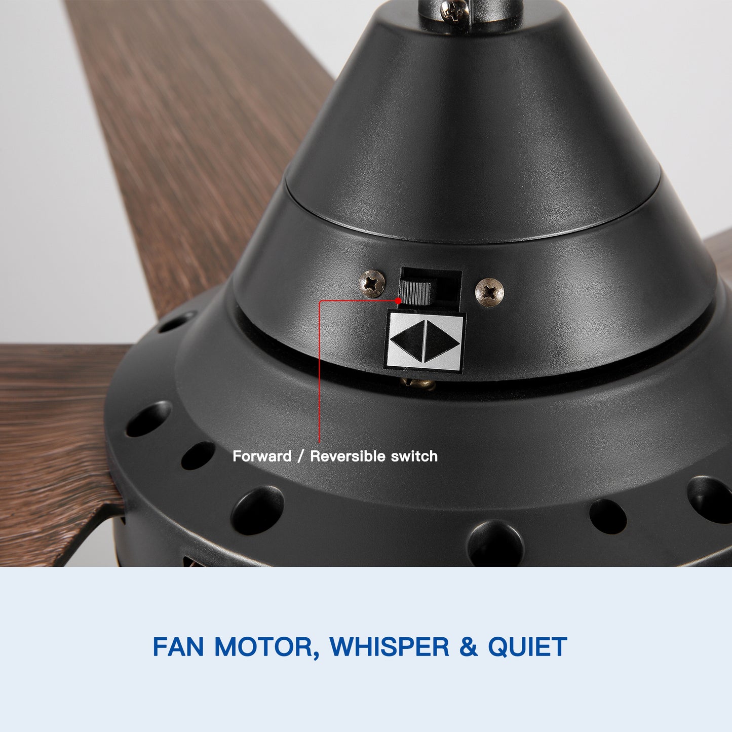 Closeup of black fan motor housing with dualdirection switch and woodgrain blade