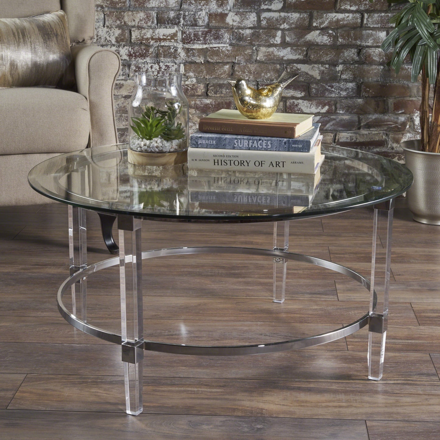 Clear glass round coffee table with acrylic legs and chrome ring accent