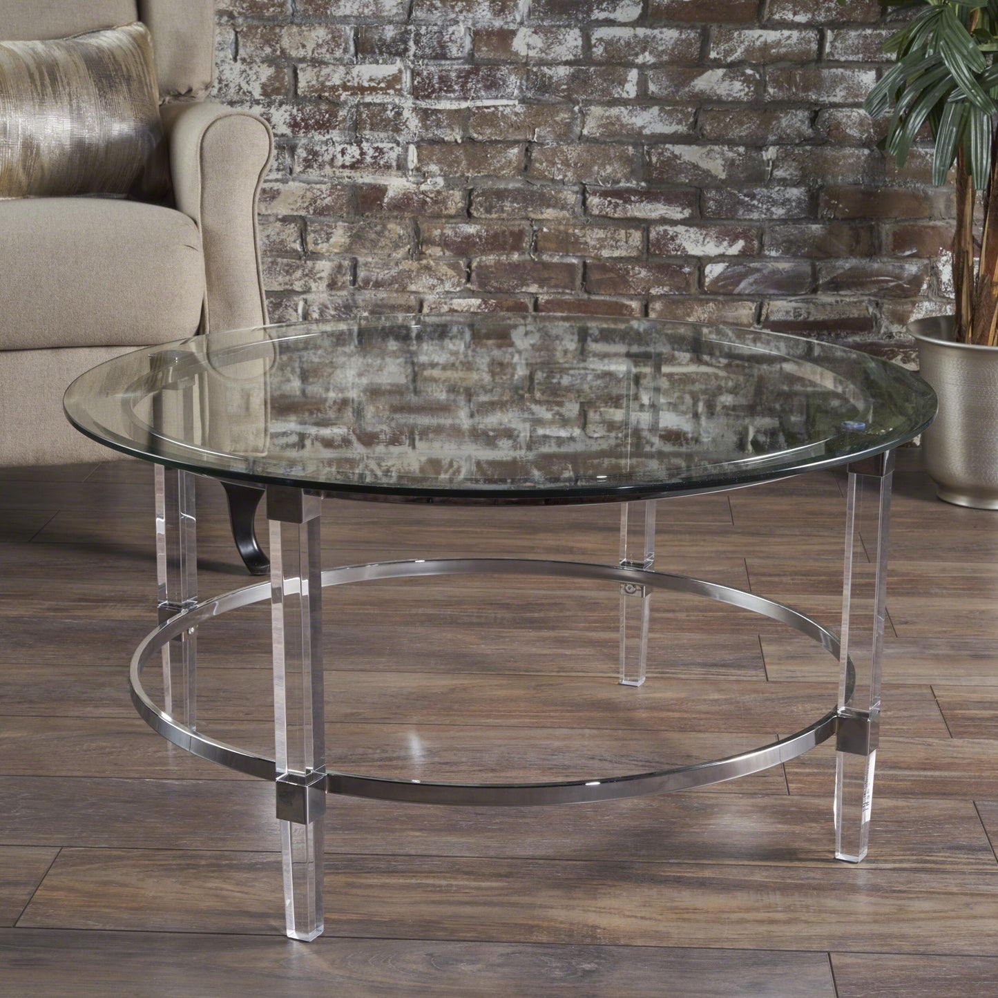 Round glass coffee table with clear acrylic and chrome legs perfect for modern living rooms