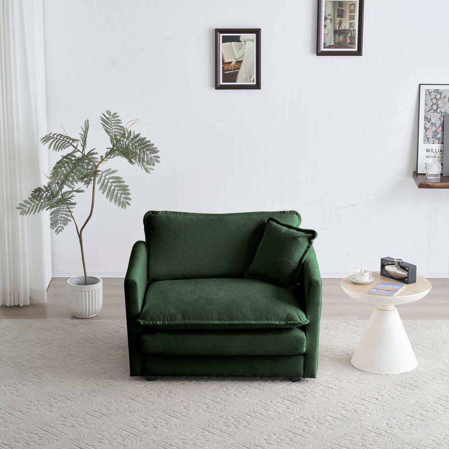 Deep green velvet armchair with plush cushions and a matching throw pillow