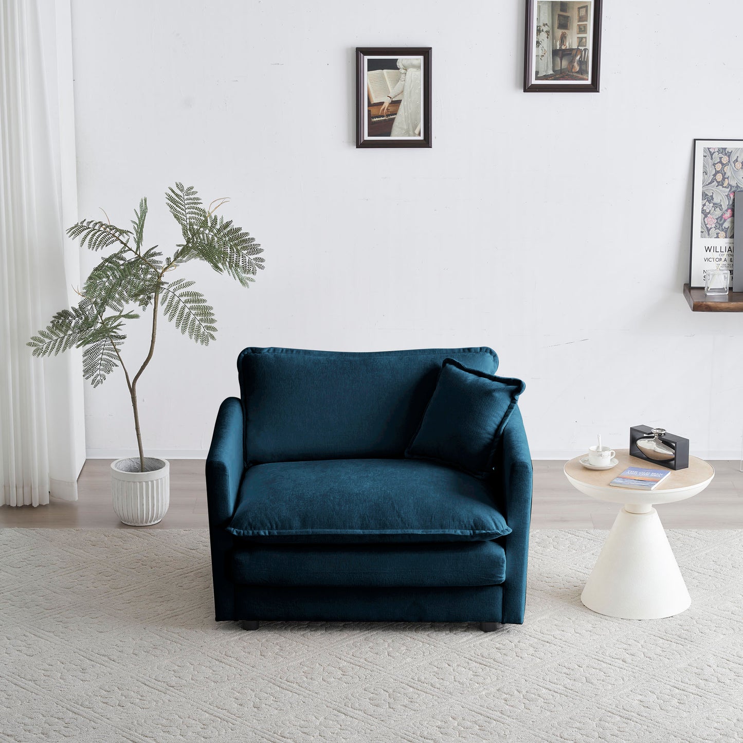 Plush teal velvet accent chair with matching pillow ideal for small spaces