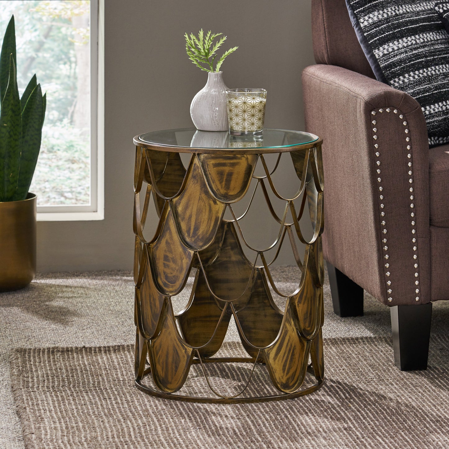 Glamorous gold metal round accent table with glass top and scalelike design