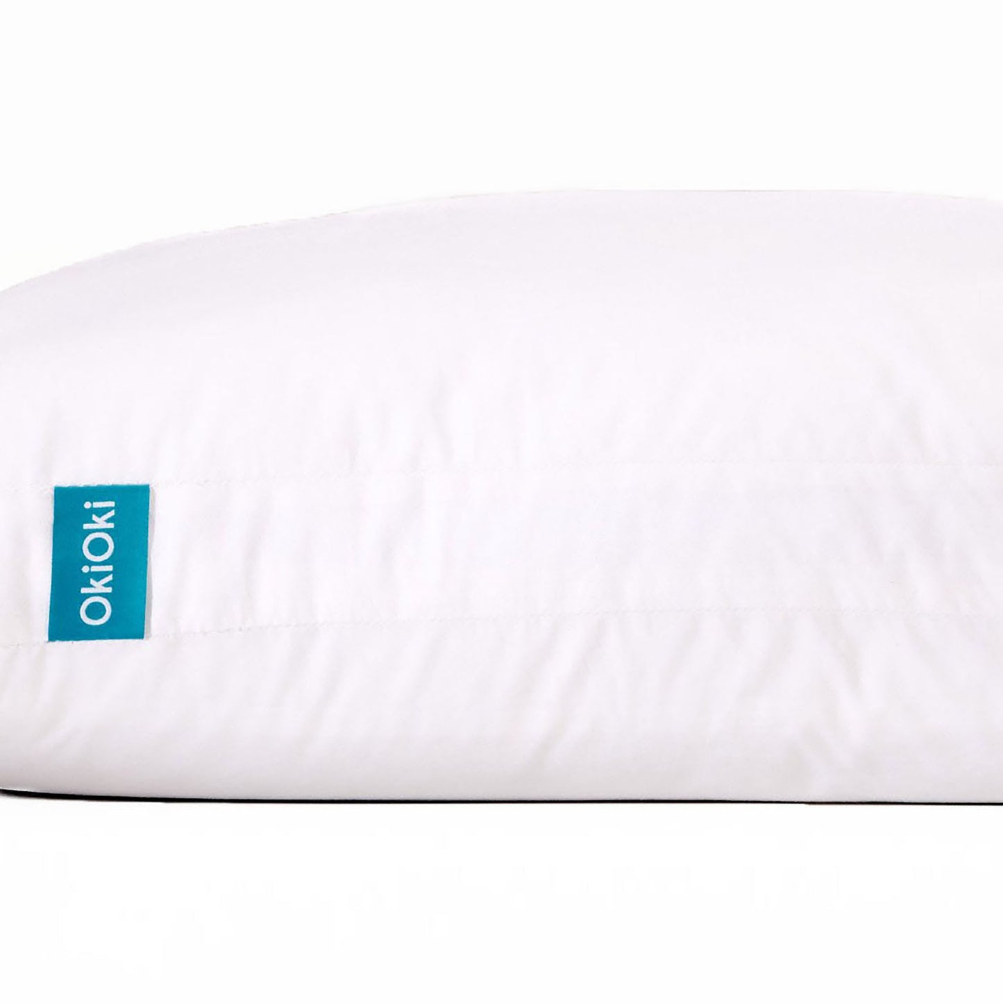 White OkiOki pillow with teal tag comfortable for sleeping