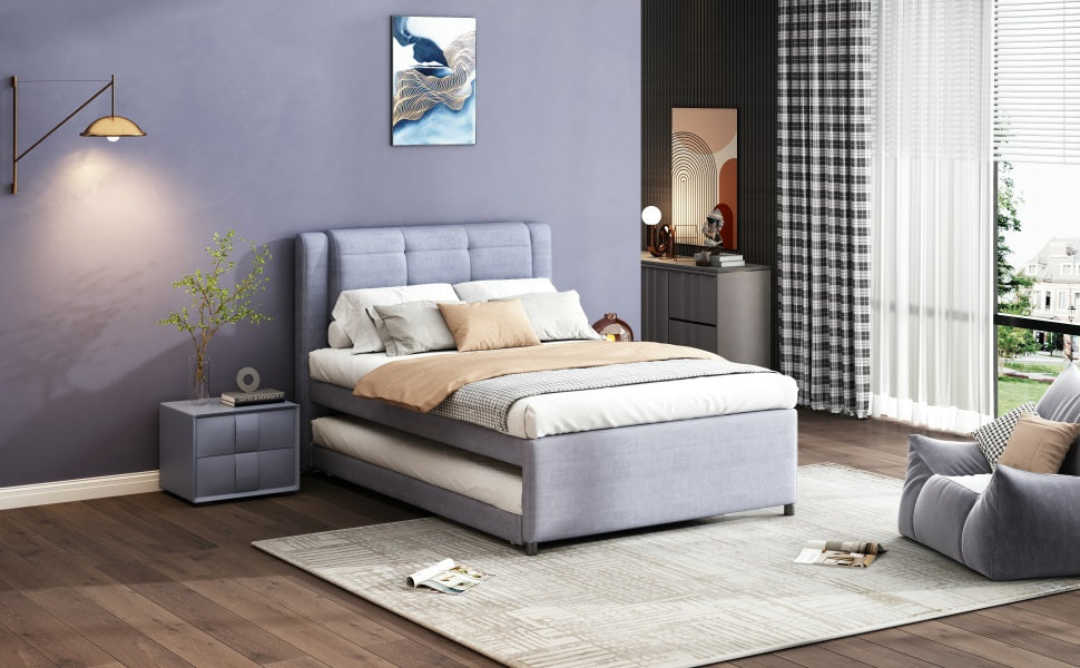 Light blue upholstered bed with pullout trundle for guest use